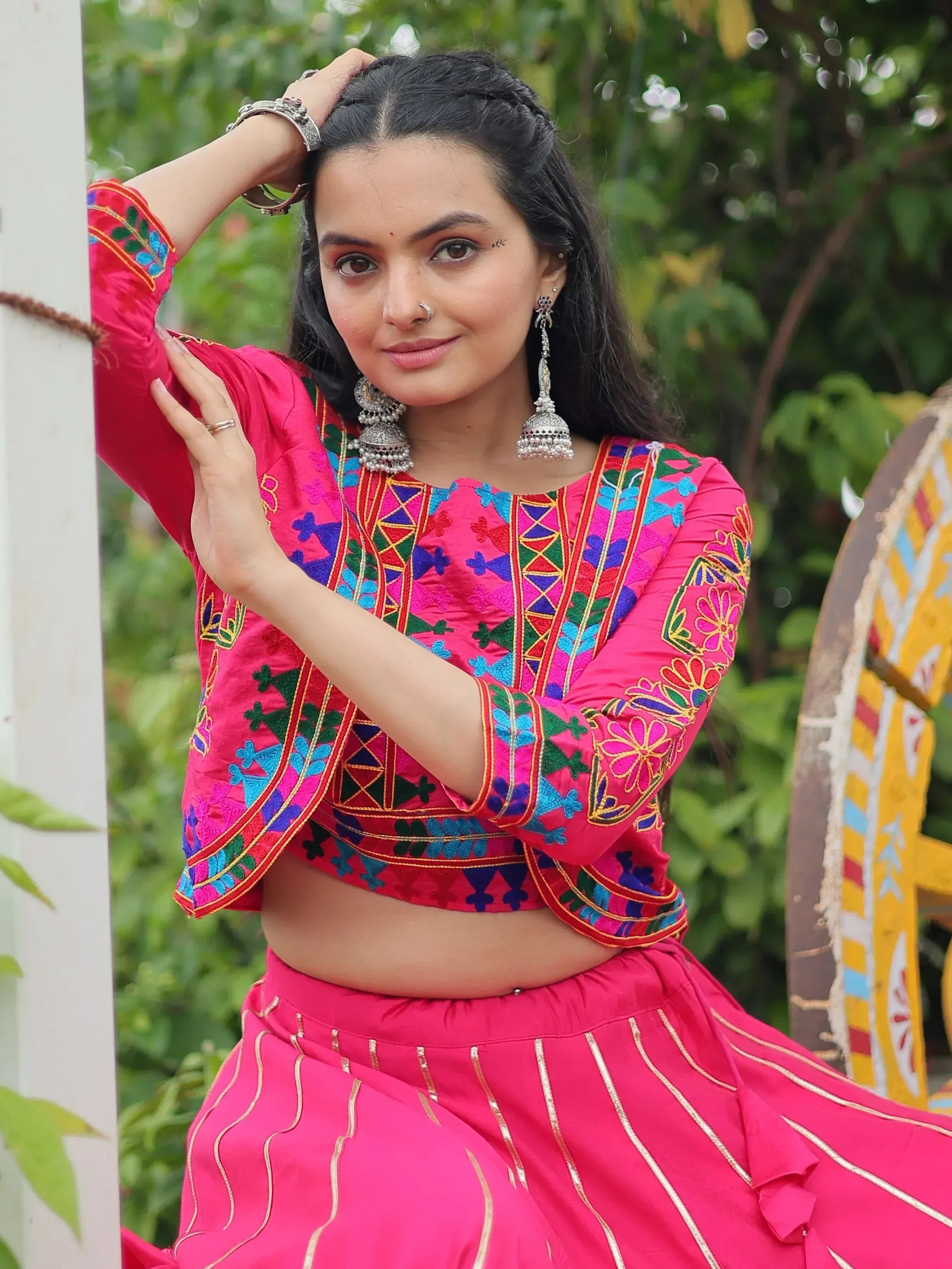 Vibrant pink embroidered lehenga choli with colorful mirror work, perfect for Indian ethnic wear