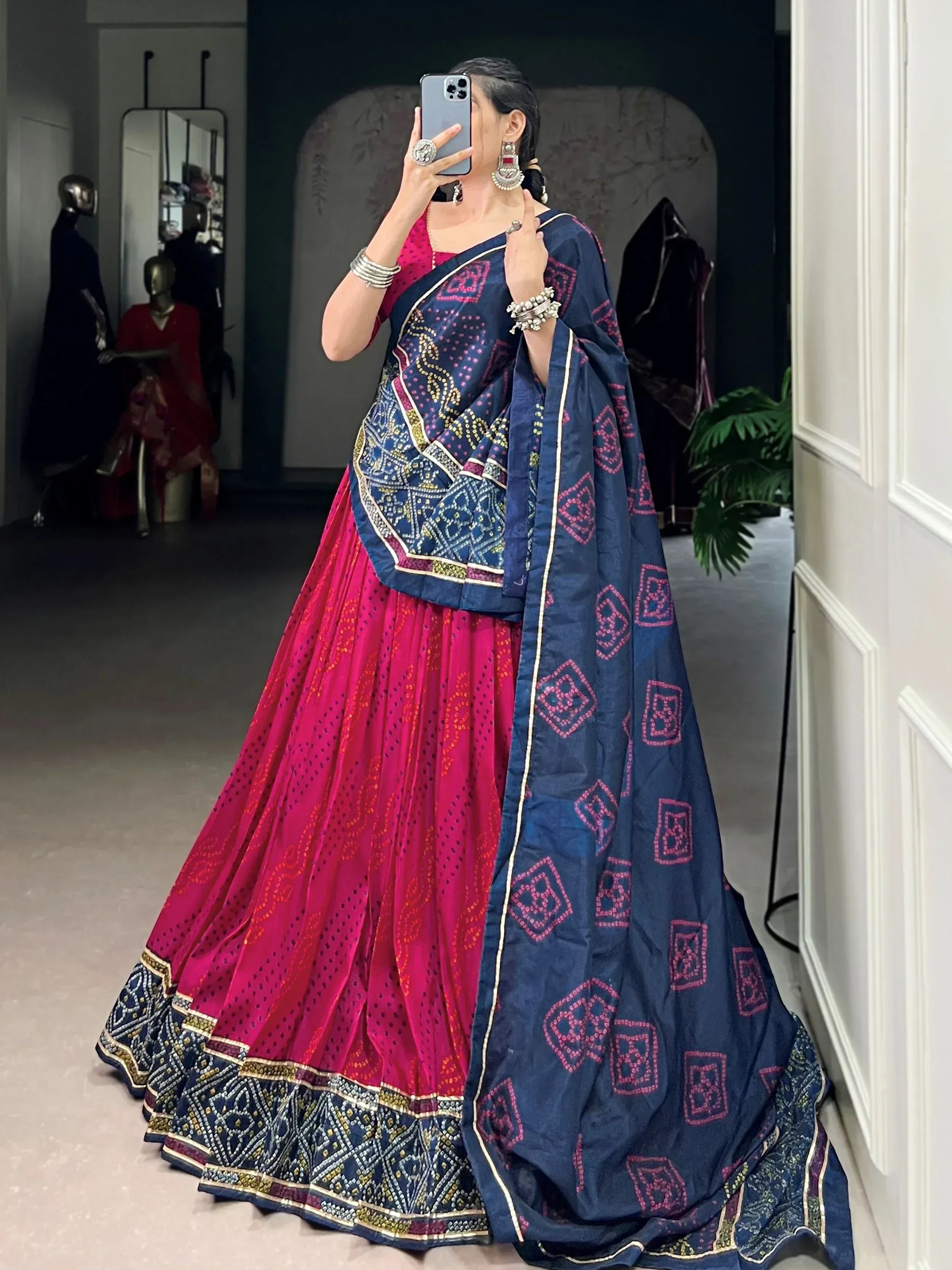 Woman in vibrant pink lehenga with navy blue embroidered dupatta, traditional Indian ethnic wear