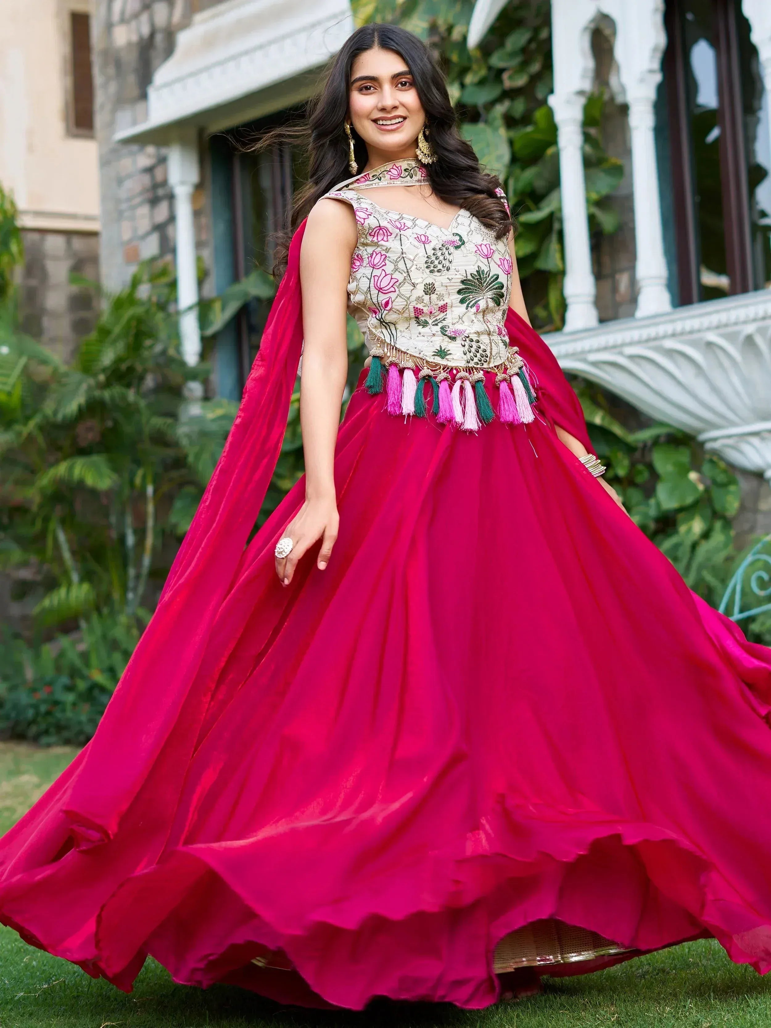 Elegant pink lehenga choli with floral embroidery and tassels, perfect for Indian ethnic wear