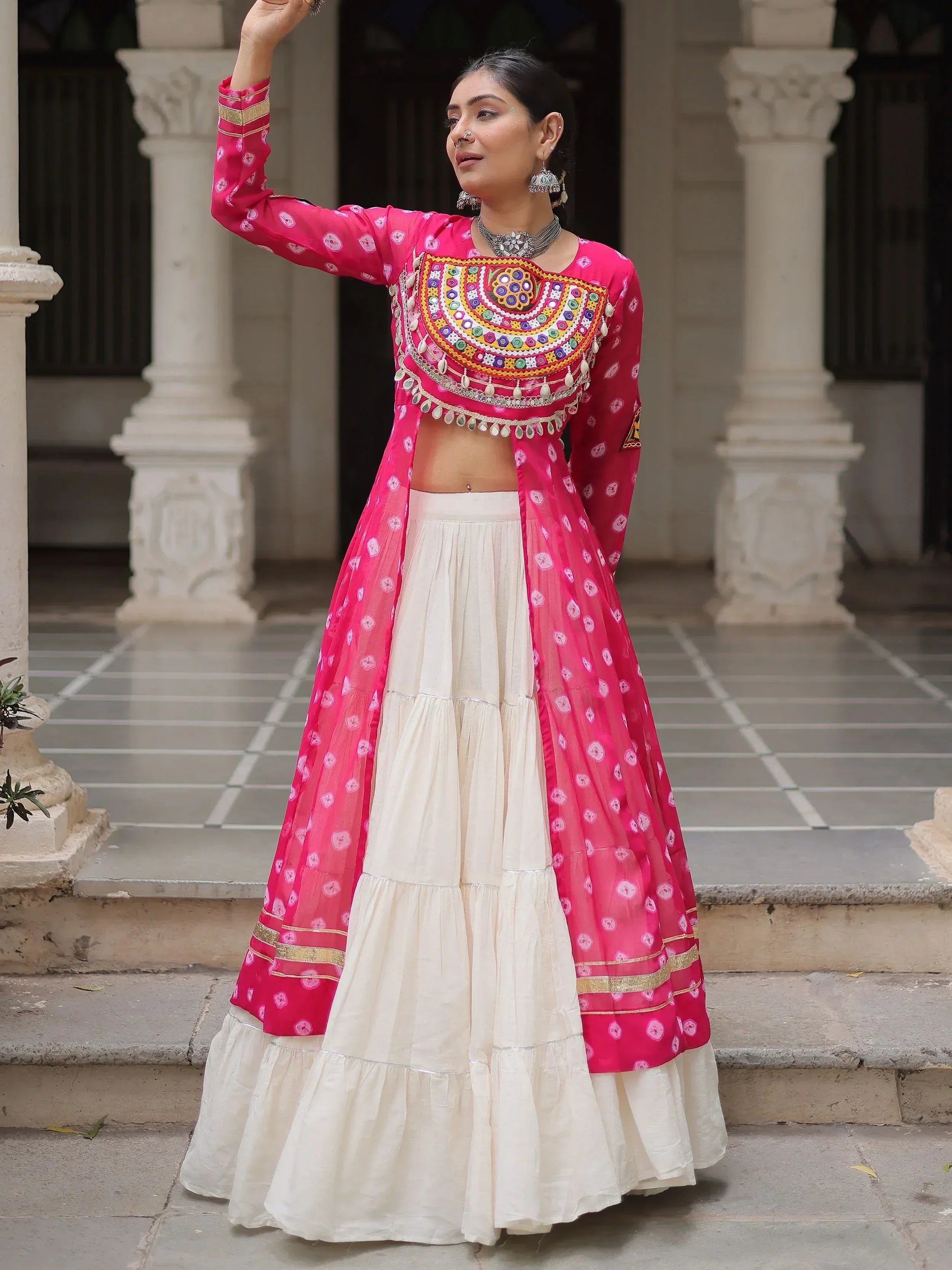 Pink embroidered Indian lehenga choli with white tiered skirt, traditional ethnic wear for women