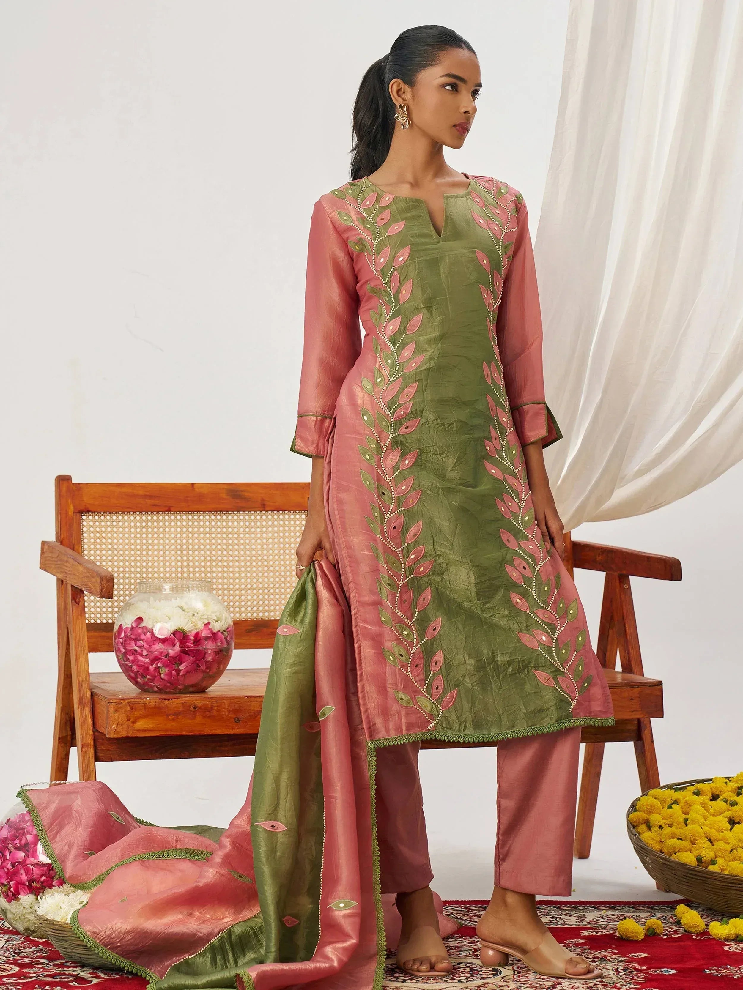 Green and pink embroidered salwar kameez with floral design, perfect for ethnic wear occasions.