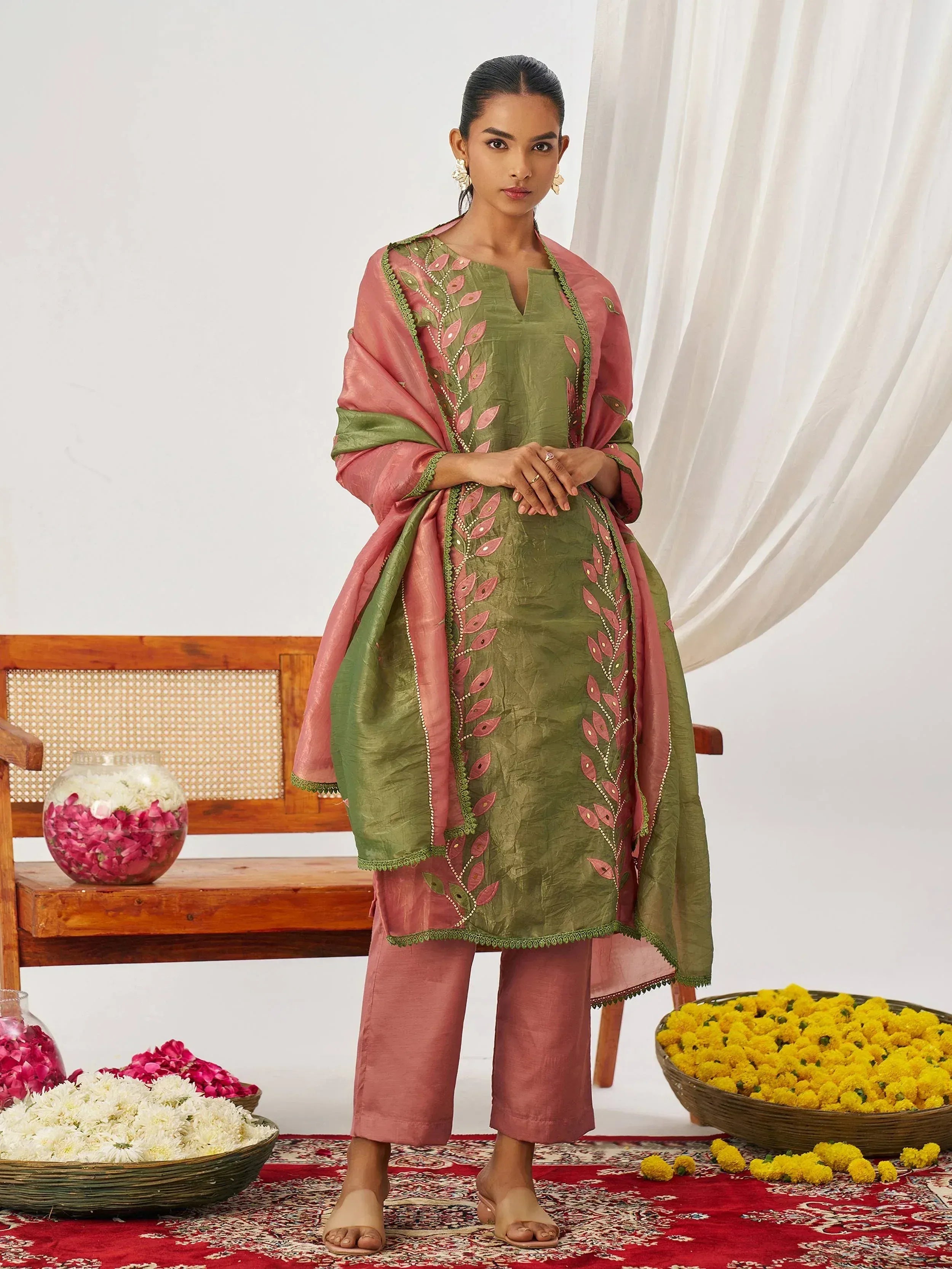 Green and pink embroidered salwar kameez with floral motifs, perfect for Indian ethnic wear occasions.