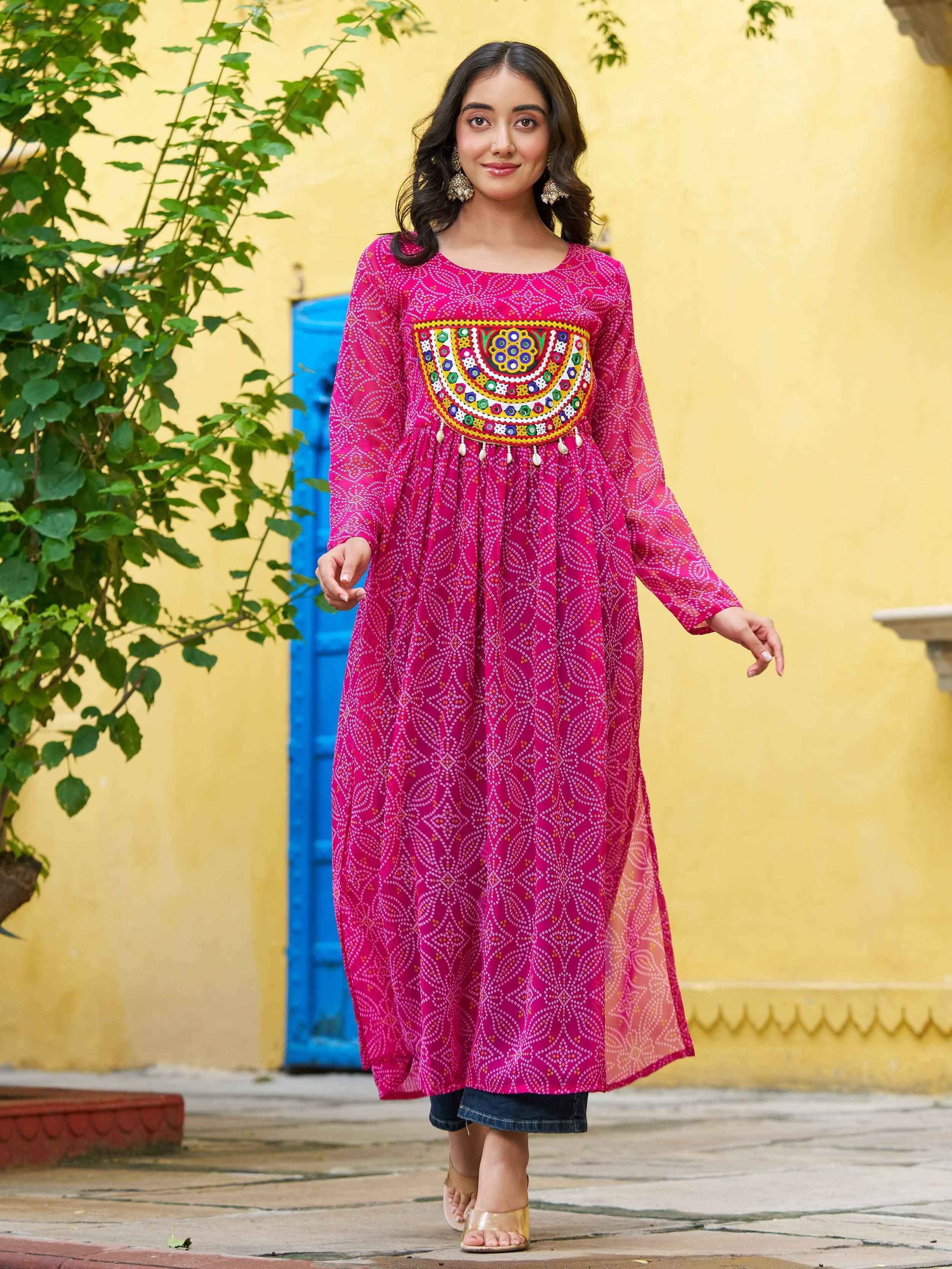 Pink ethnic kurta with mirror work and printed patterns, styled with jeans for casual wear