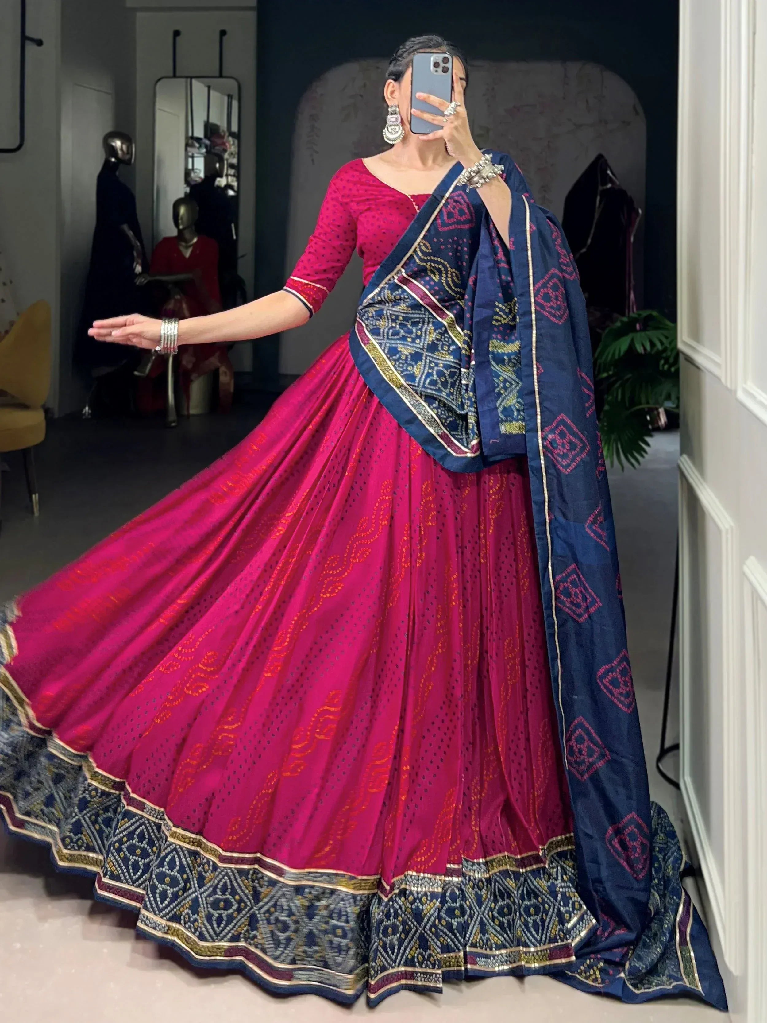 Vibrant pink lehenga choli with navy blue dupatta, featuring intricate embroidery and traditional Indian ethnic wear design.