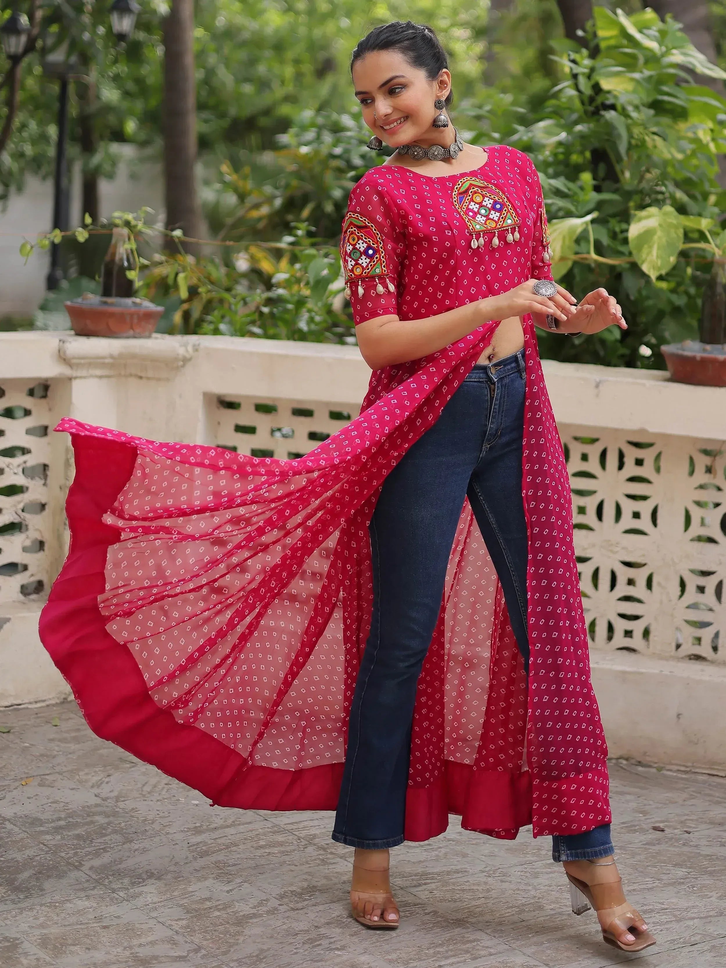 Woman in red embroidered ethnic kurta with denim jeans, perfect for Indian festive wear