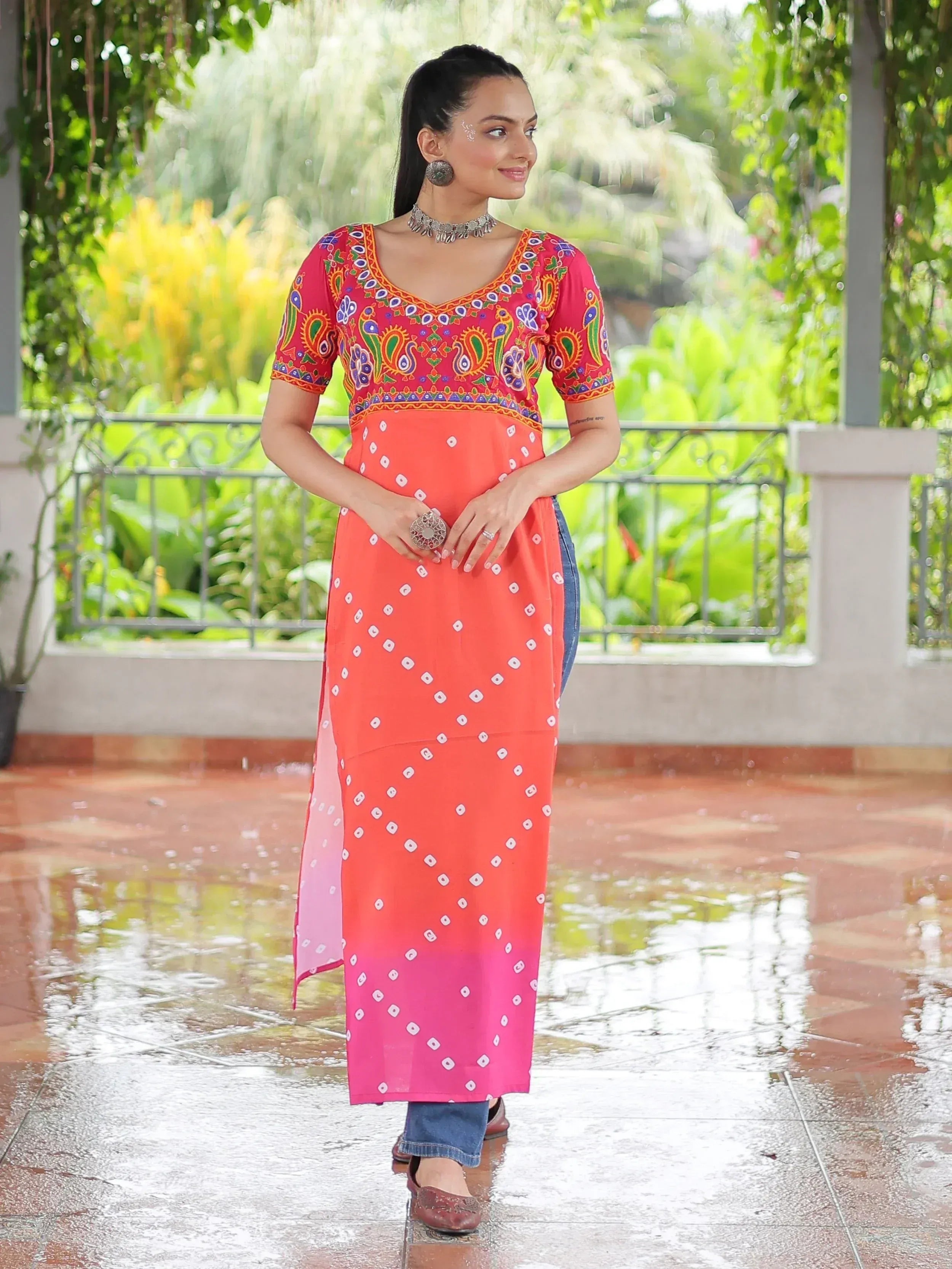Woman in colorful embroidered ethnic kurta with ombre dupatta, styled with jeans for casual Indian wear