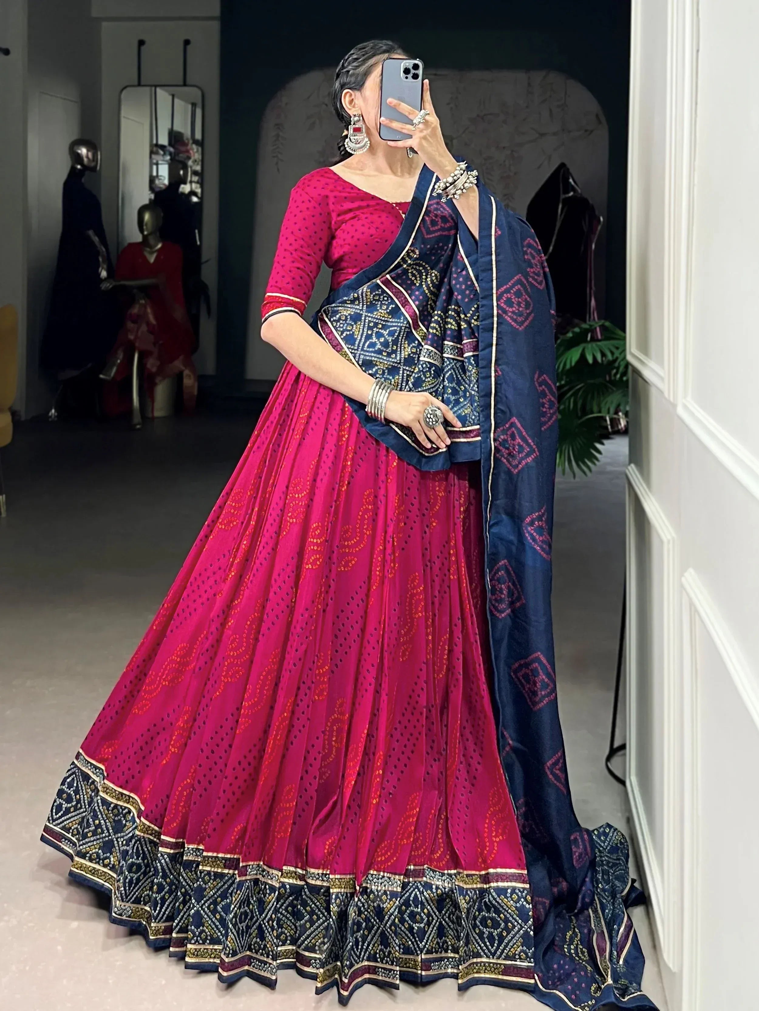 Woman in pink and navy blue embroidered lehenga choli with dupatta, traditional Indian ethnic wear