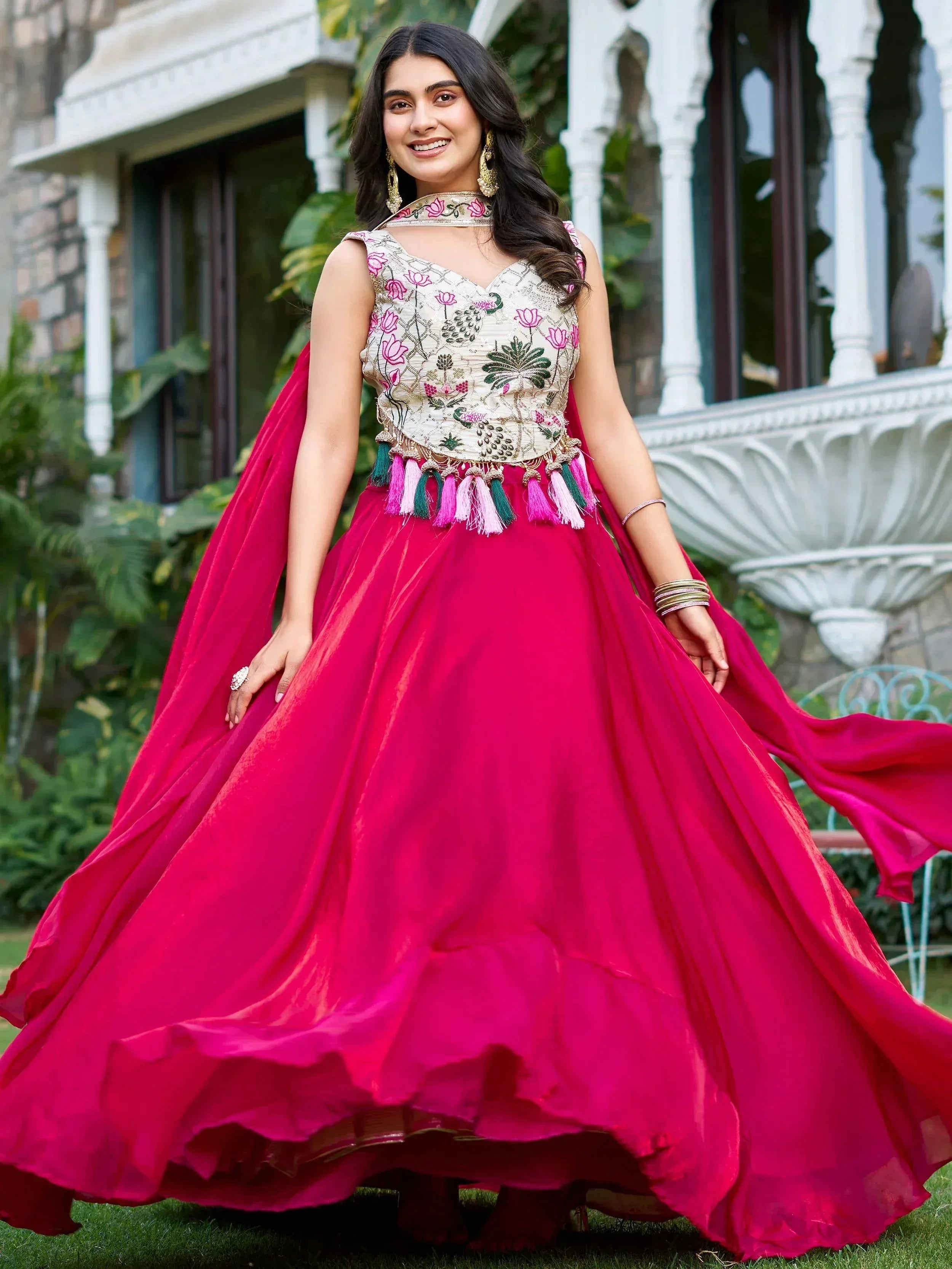 Elegant pink lehenga choli with floral embroidery and tassels, perfect for Indian ethnic wear