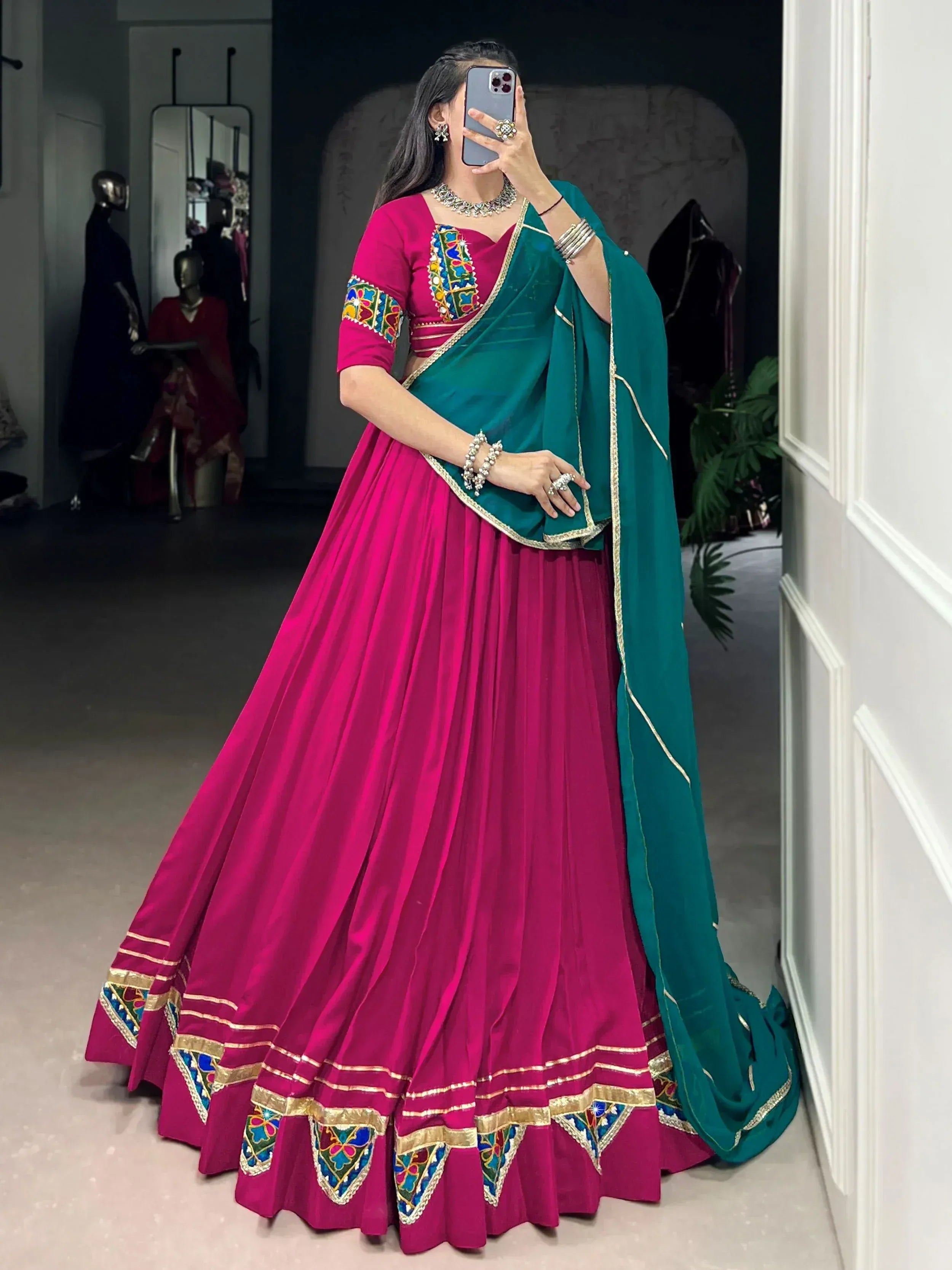 Fuchsia lehenga choli with green dupatta, colorful embroidery, gold trim, perfect for Indian ethnic wear occasions