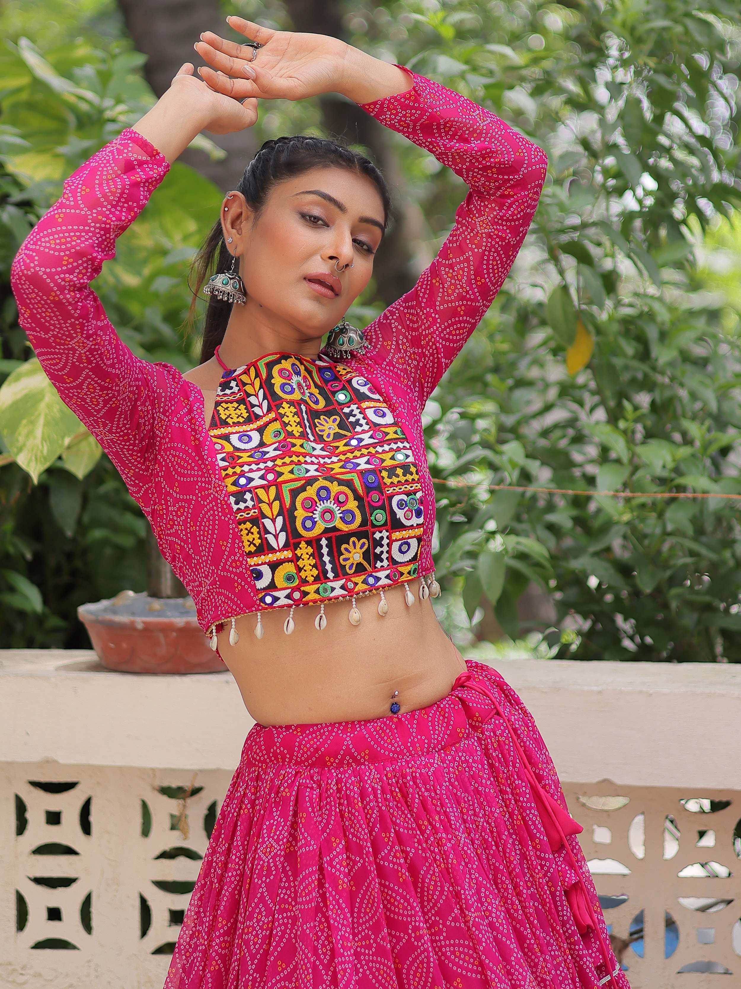 Pink embroidered lehenga choli with mirror work and shell tassels, ideal for Indian ethnic wear