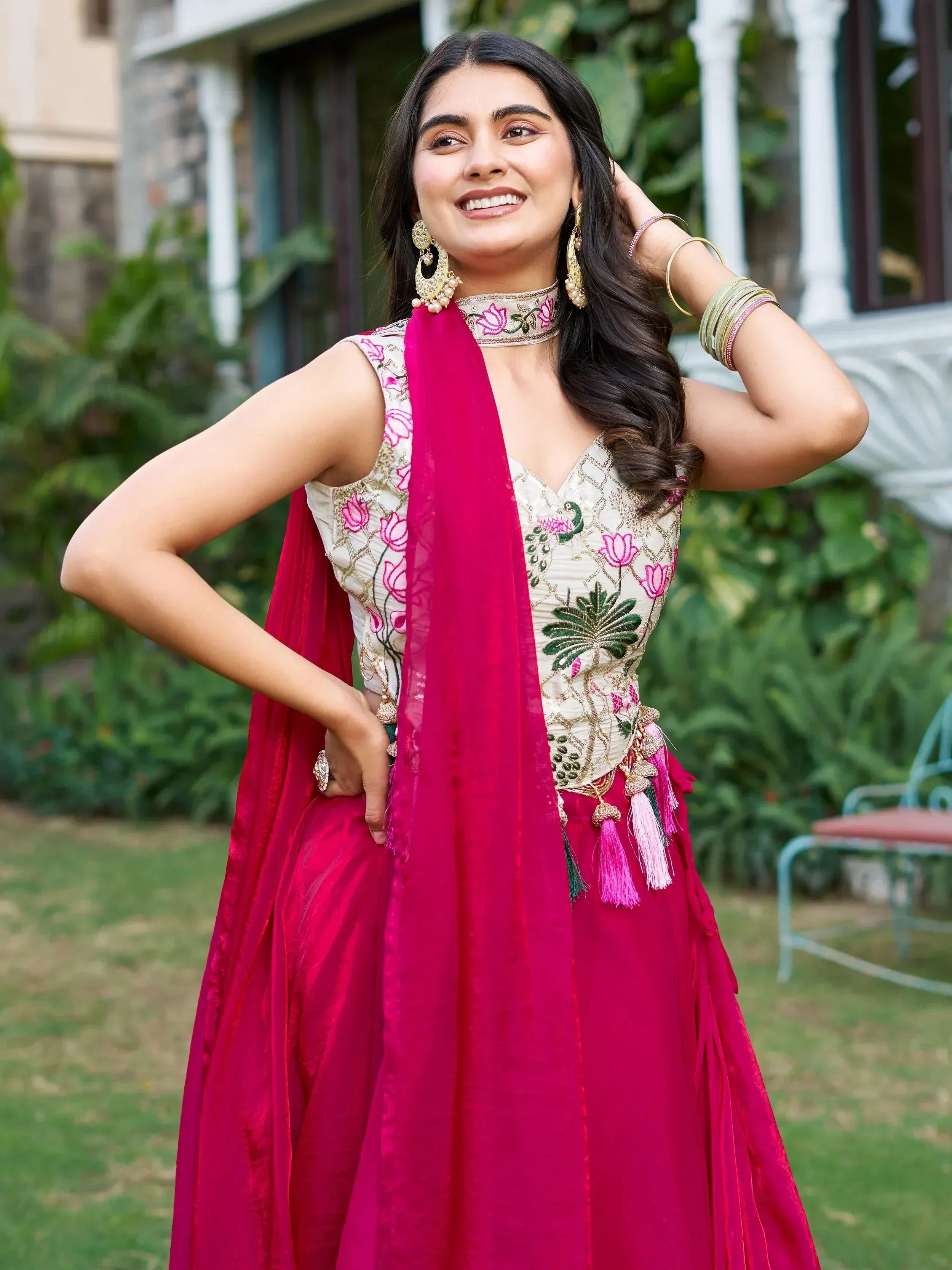 Elegant Indian ethnic wear with floral embroidery and vibrant pink dupatta, perfect for festive occasions.