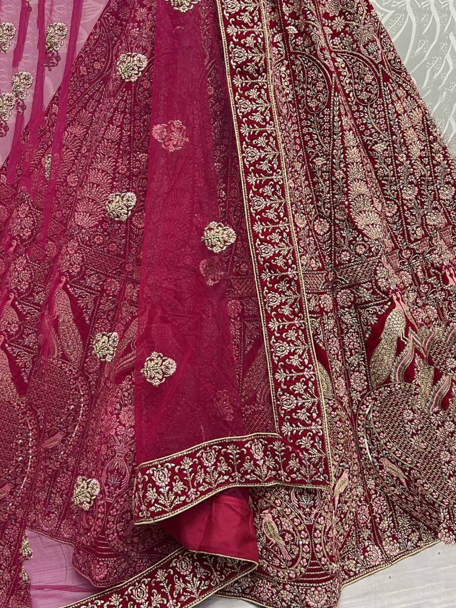 Rich maroon lehenga choli with gold embroidery and floral motifs, perfect for Indian weddings and festive occasions.
