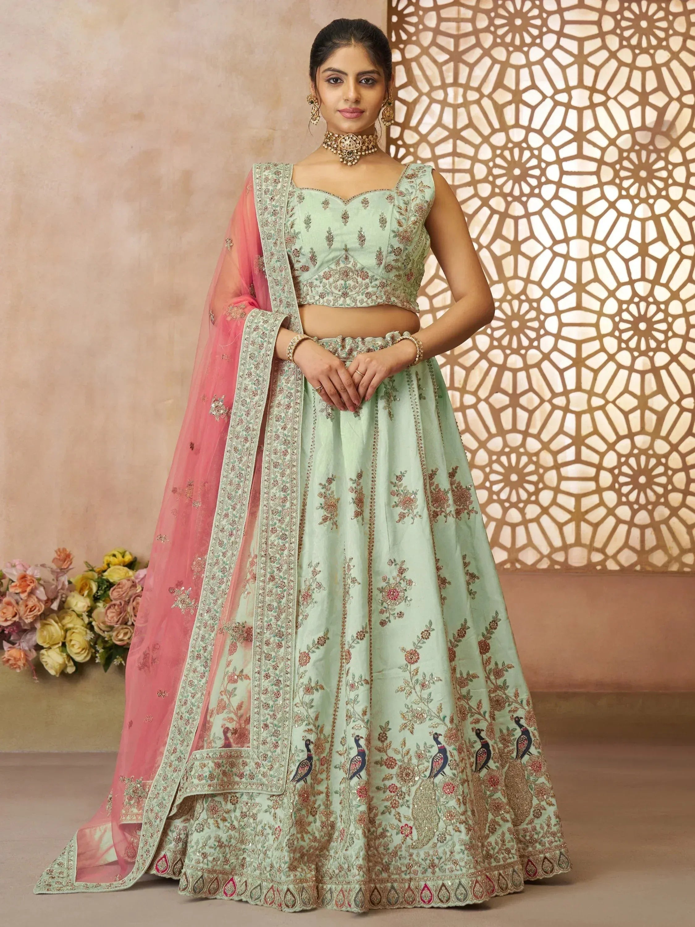 Mint green embroidered lehenga choli with pink dupatta, floral and peacock motifs, perfect for Indian weddings and festive occasions.