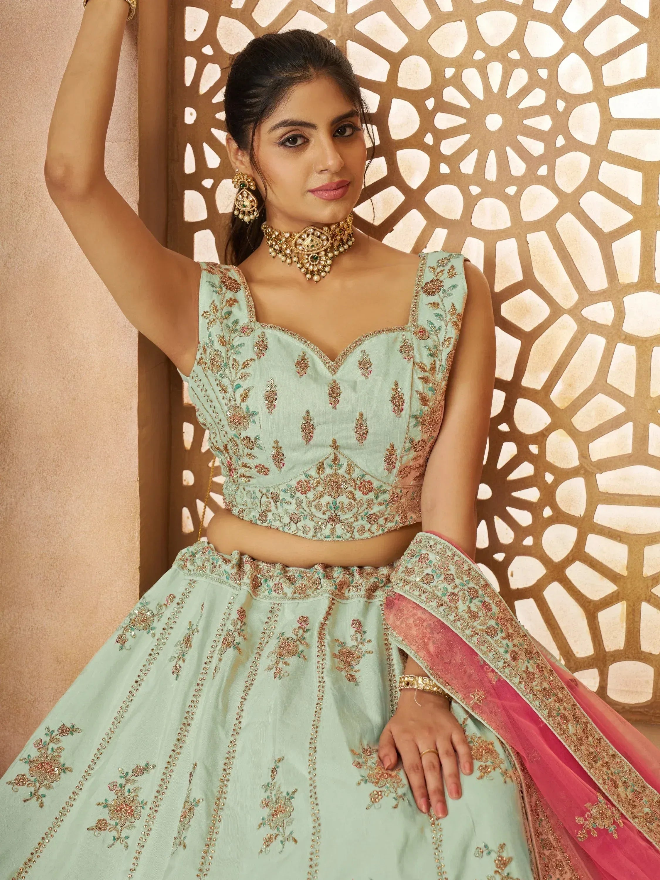 Mint green embroidered lehenga choli with pink dupatta, perfect for Indian weddings and festive occasions.