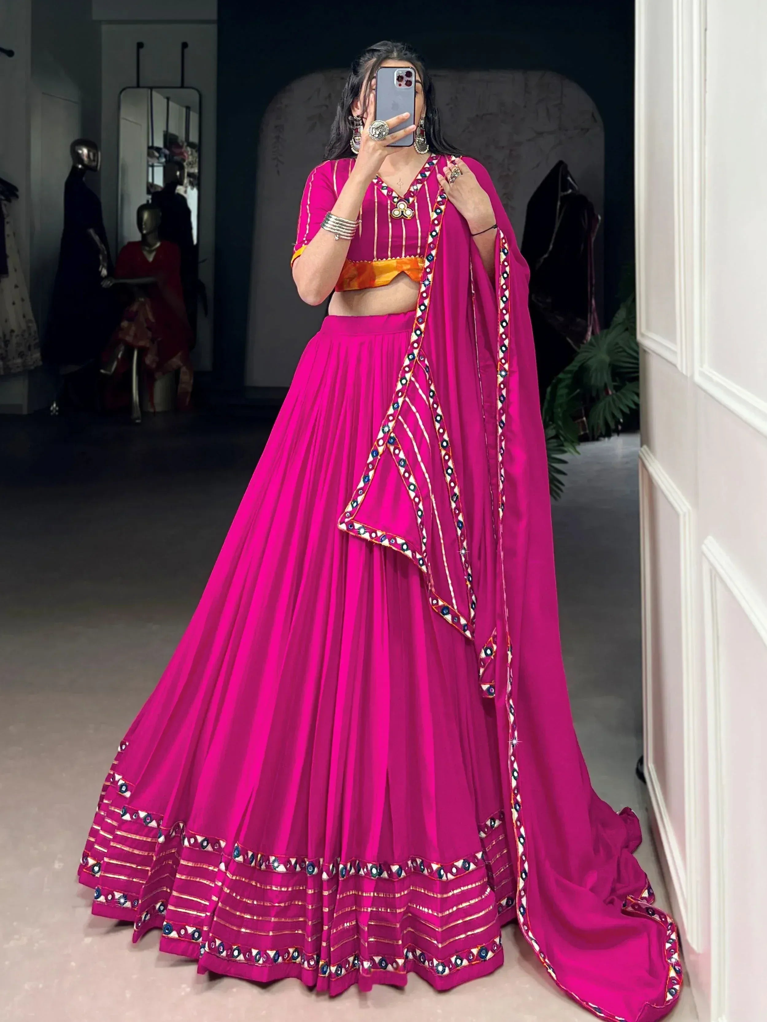 Vibrant pink lehenga choli with mirror work, perfect for Indian ethnic wear and festive occasions.