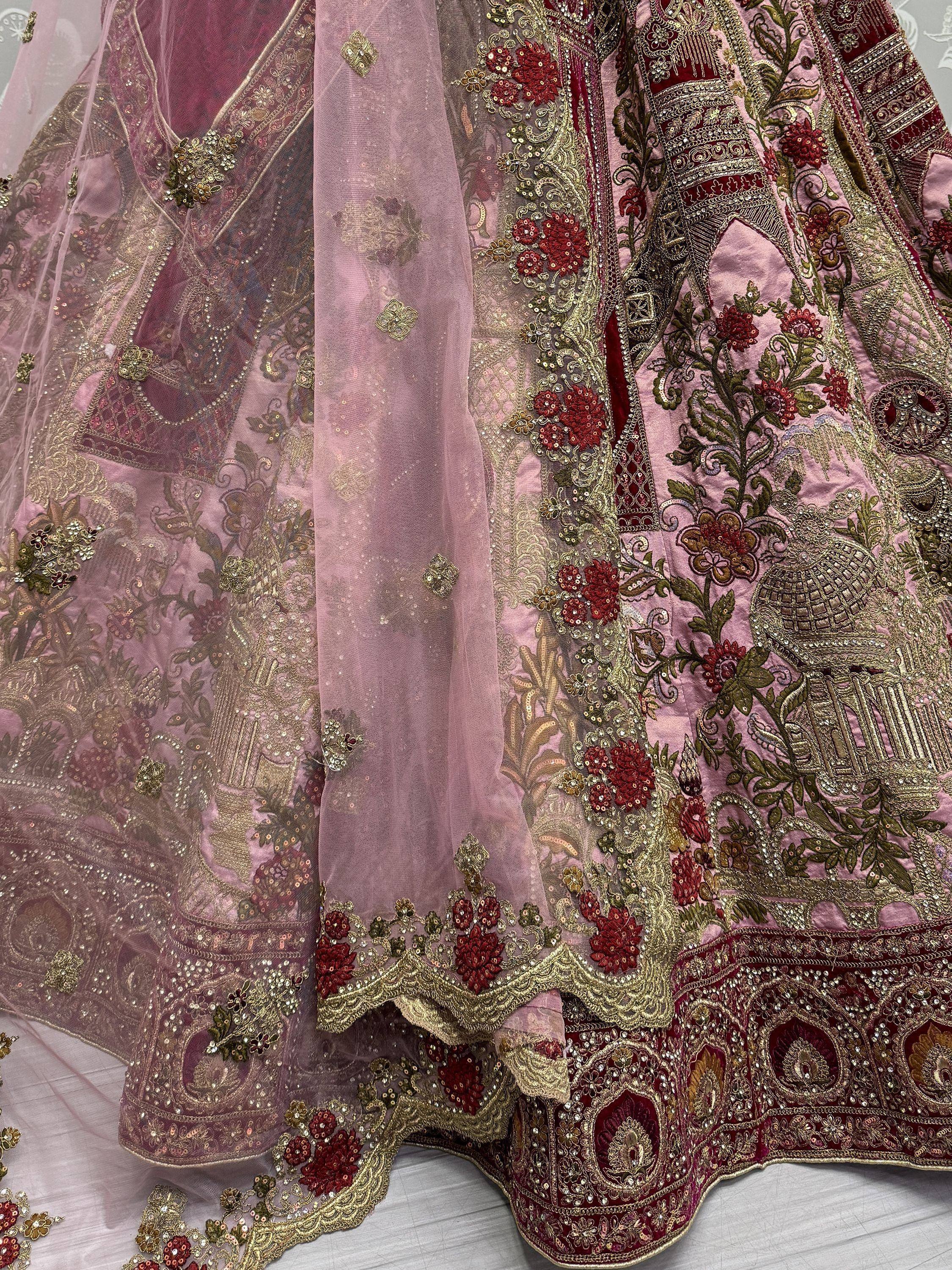 Pink and maroon designer lehenga choli with heavy gold embroidery and floral motifs, perfect for Indian weddings.