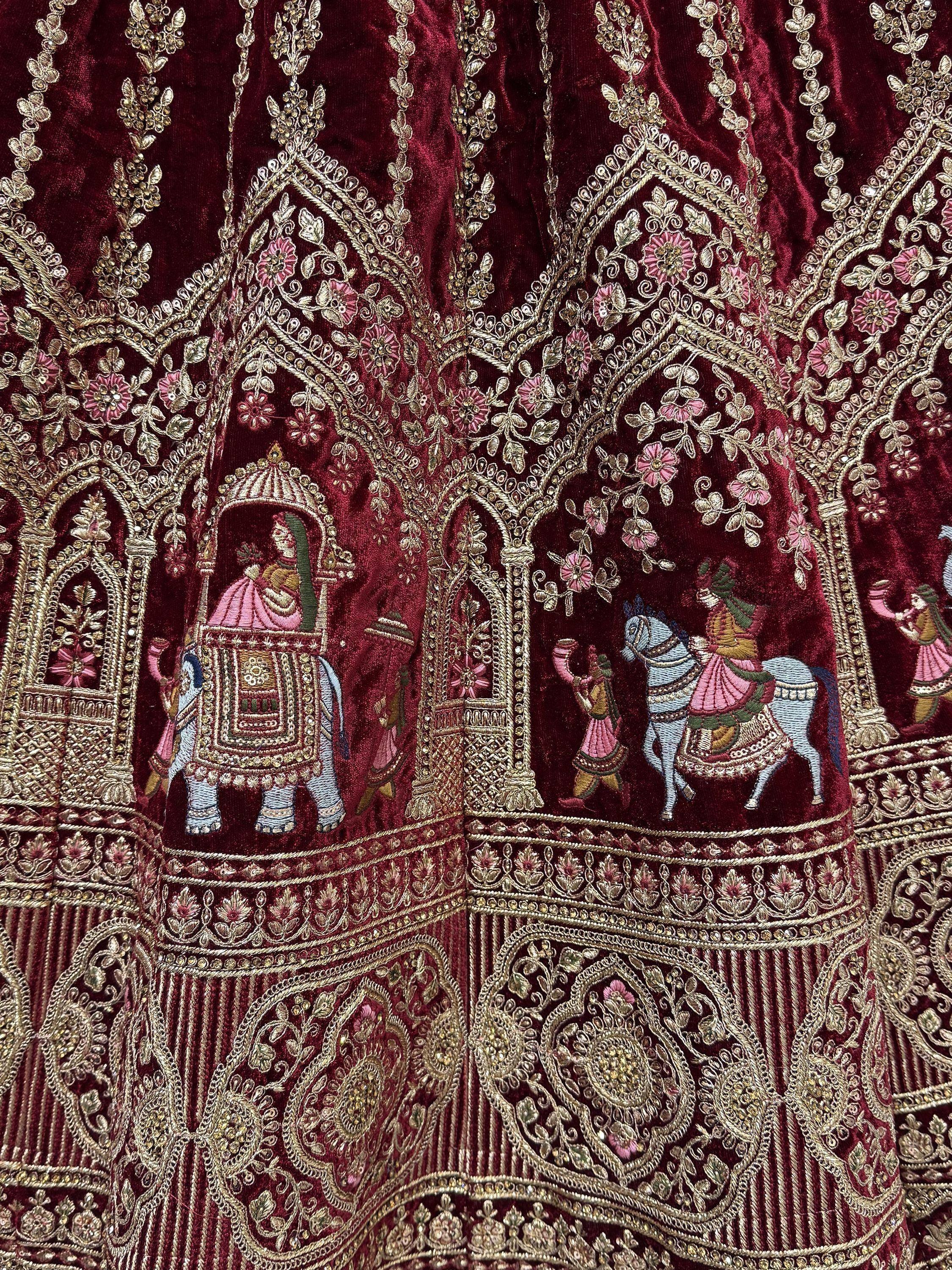 Rich maroon velvet with gold embroidery, floral motifs, and royal elephant & horse scenes for Indian ethnic wear