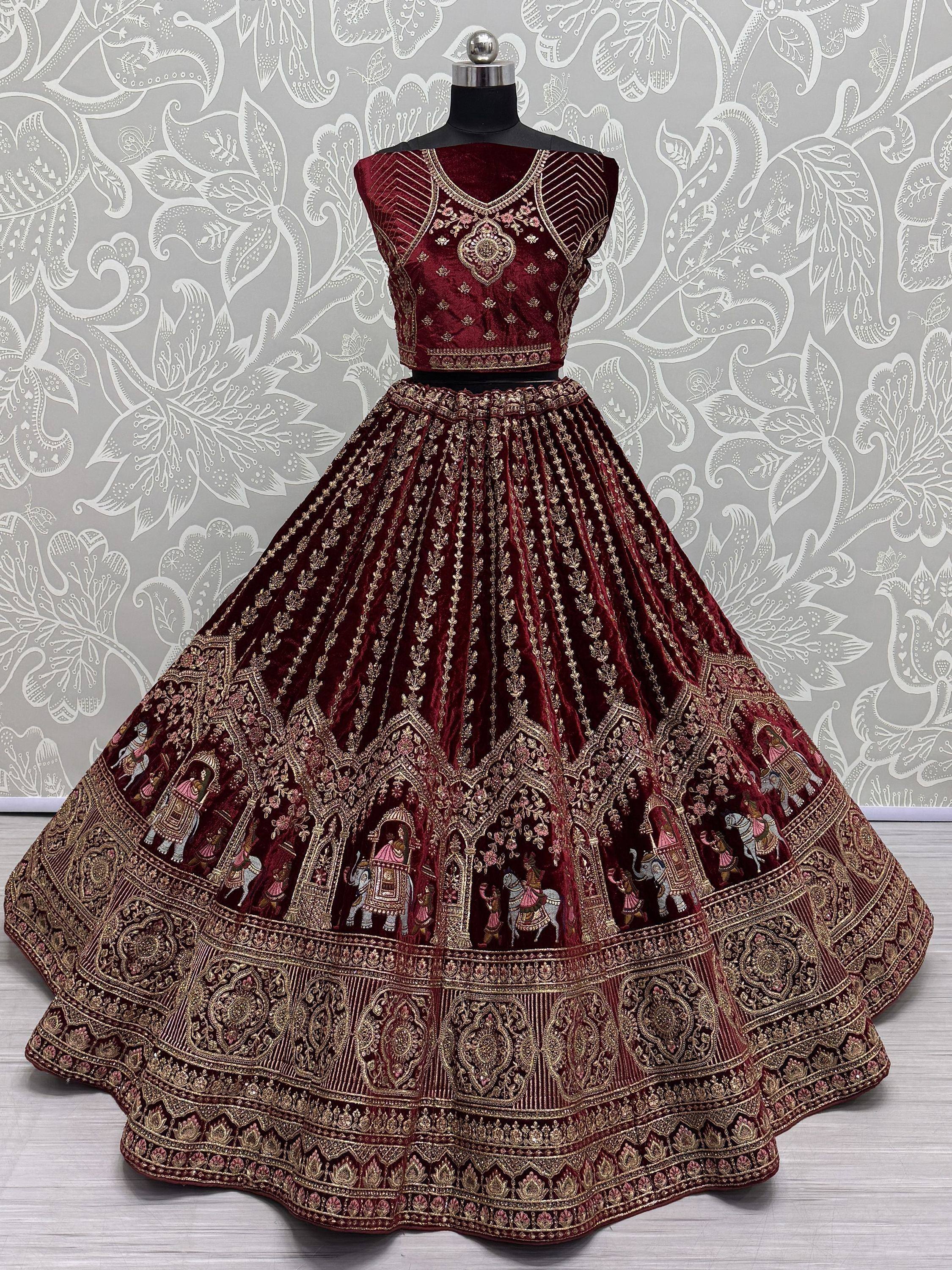 Maroon velvet lehenga choli with gold embroidery and elephant motifs, perfect for Indian weddings and festivals.