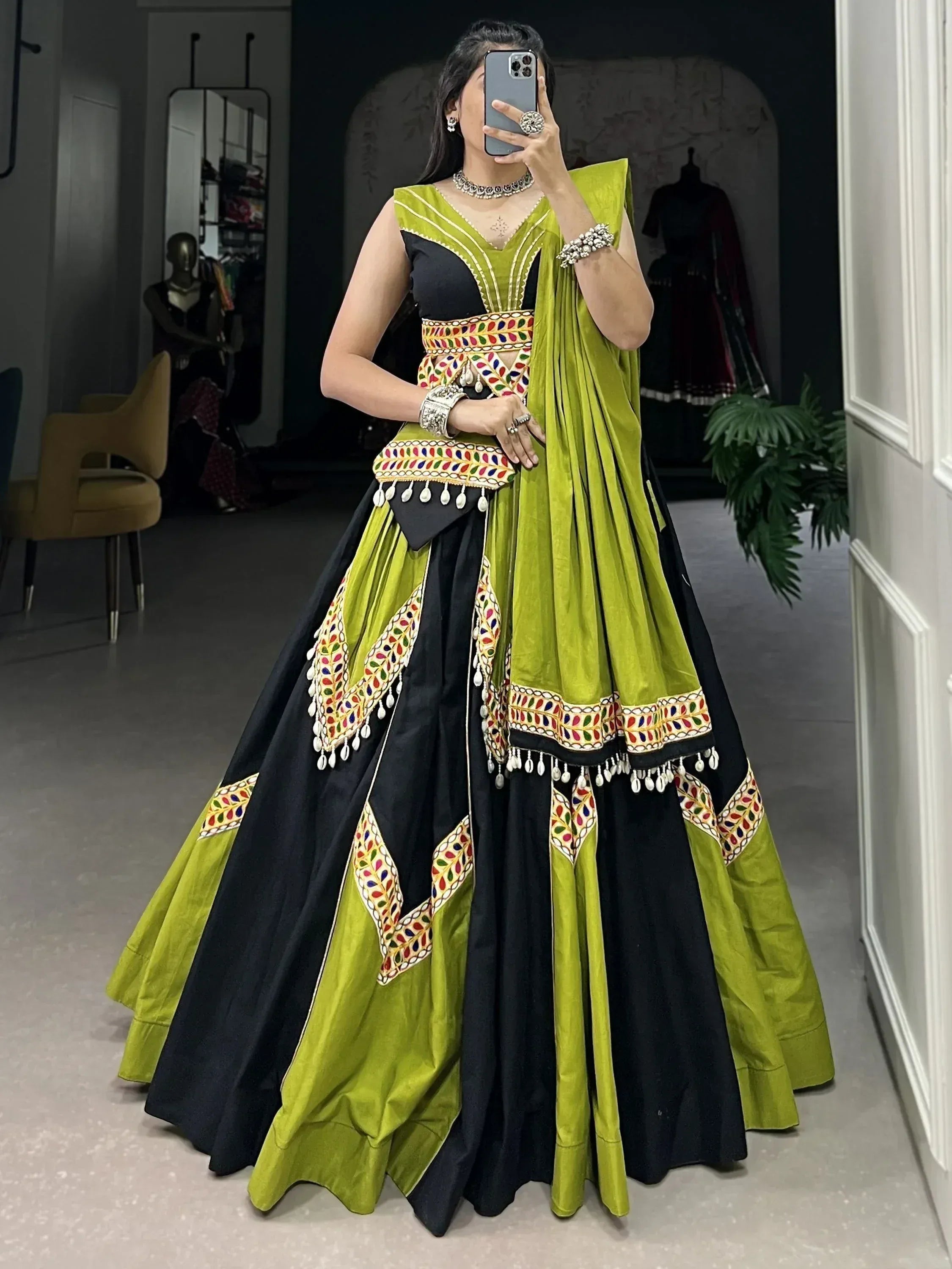 Black and lime green designer lehenga choli with colorful mirror work and tassels, perfect for Indian ethnic wear.