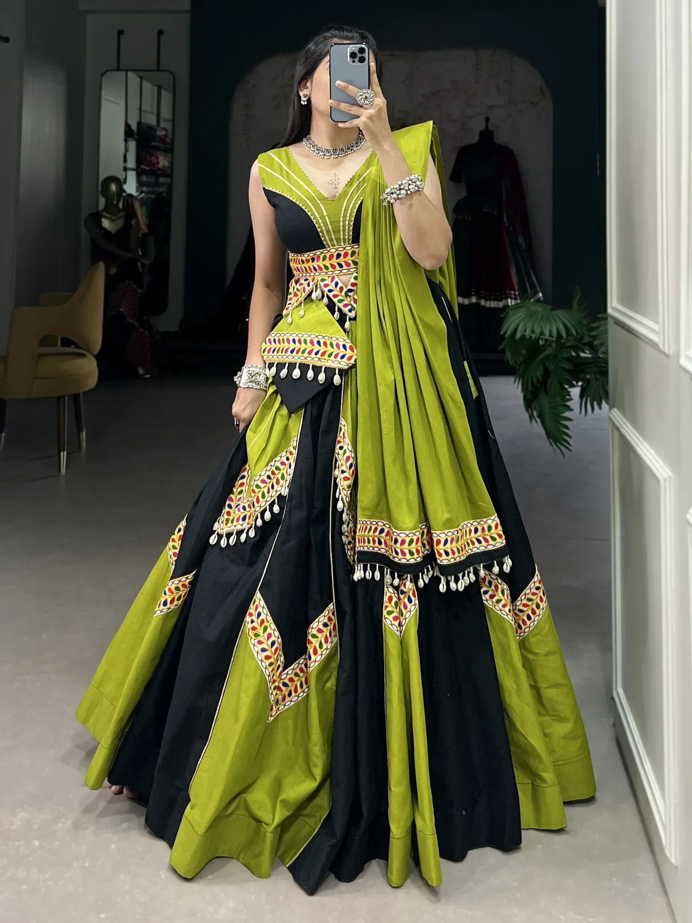Green and black designer lehenga choli with mirror work and tassels, ethnic Indian wear