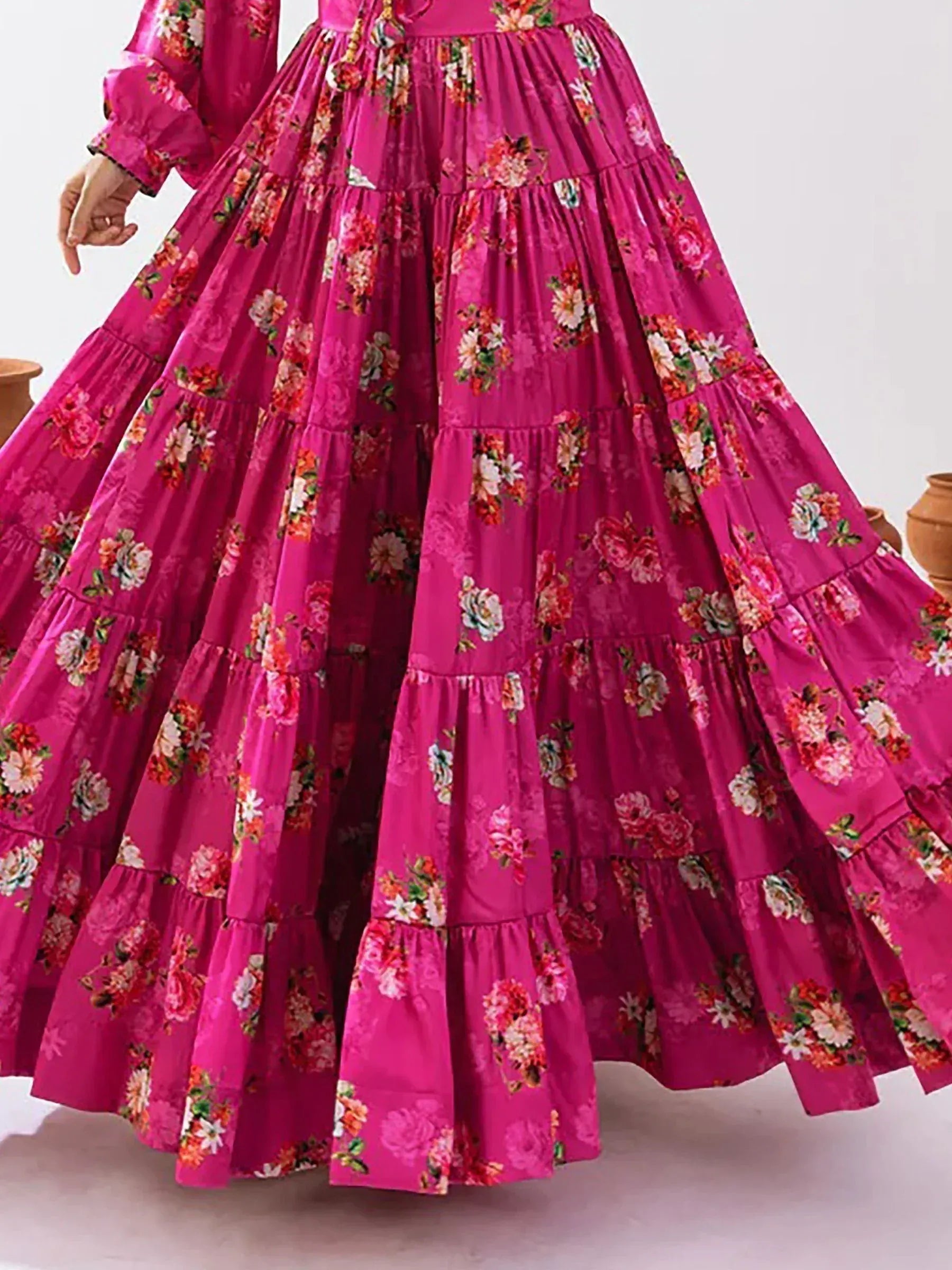 Vibrant pink floral ethnic gown with tiered ruffle skirt, perfect for festive occasions
