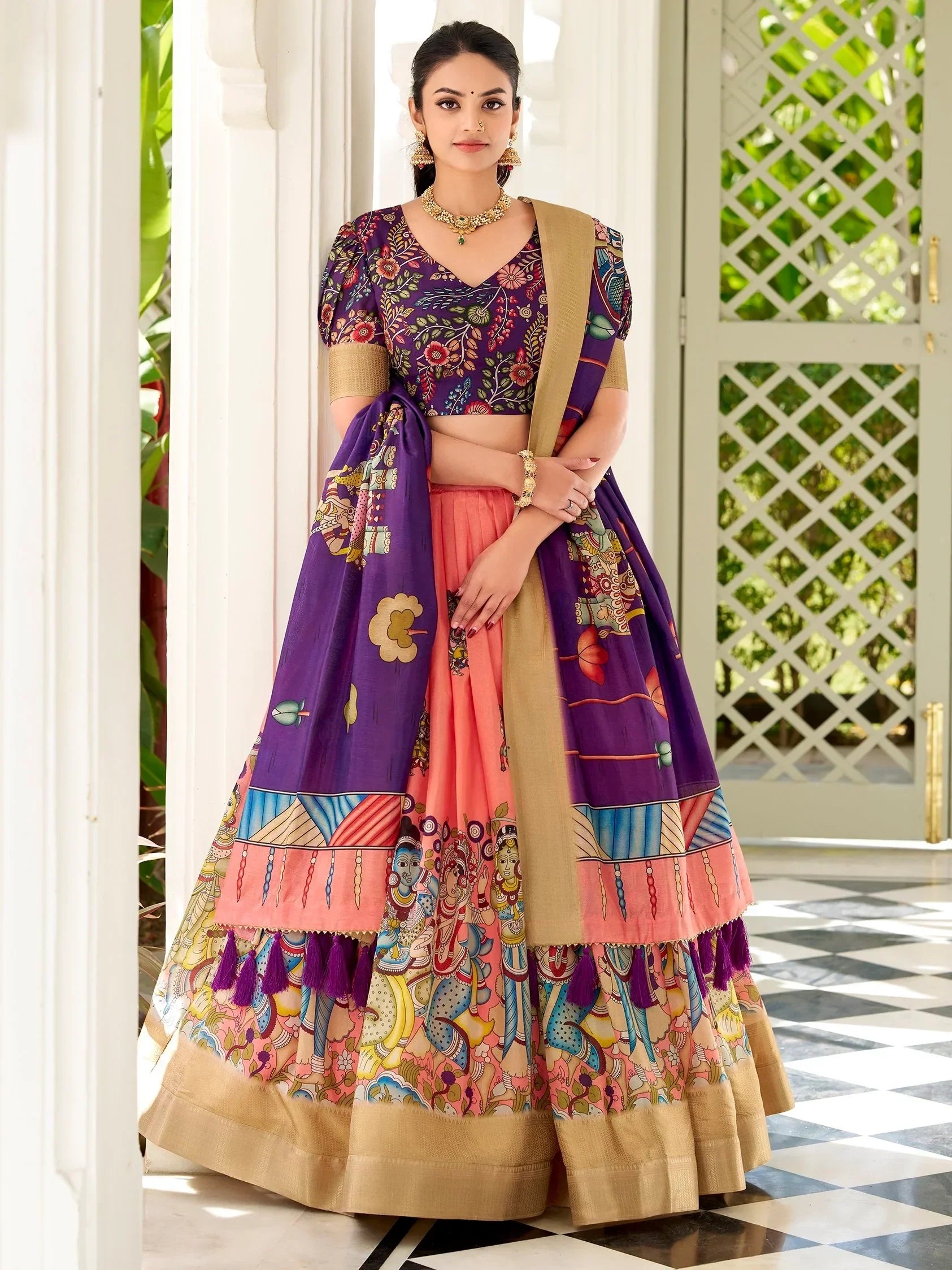 Purple and peach printed lehenga choli with ethnic motifs, perfect for Indian weddings and festive occasions.