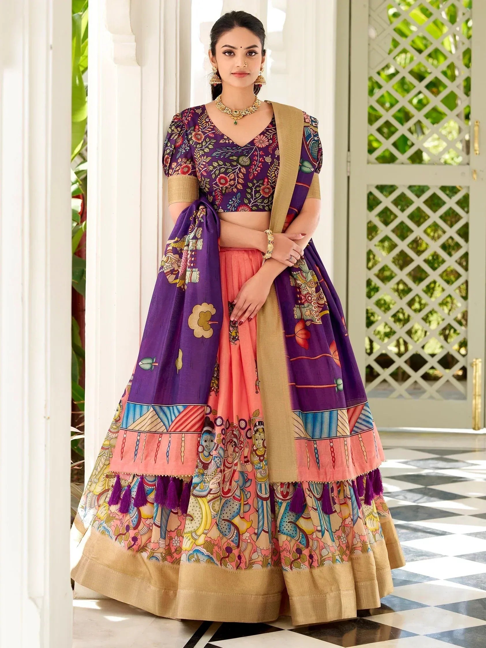 Purple and peach printed lehenga choli with ethnic motifs, perfect for Indian weddings and festive occasions.