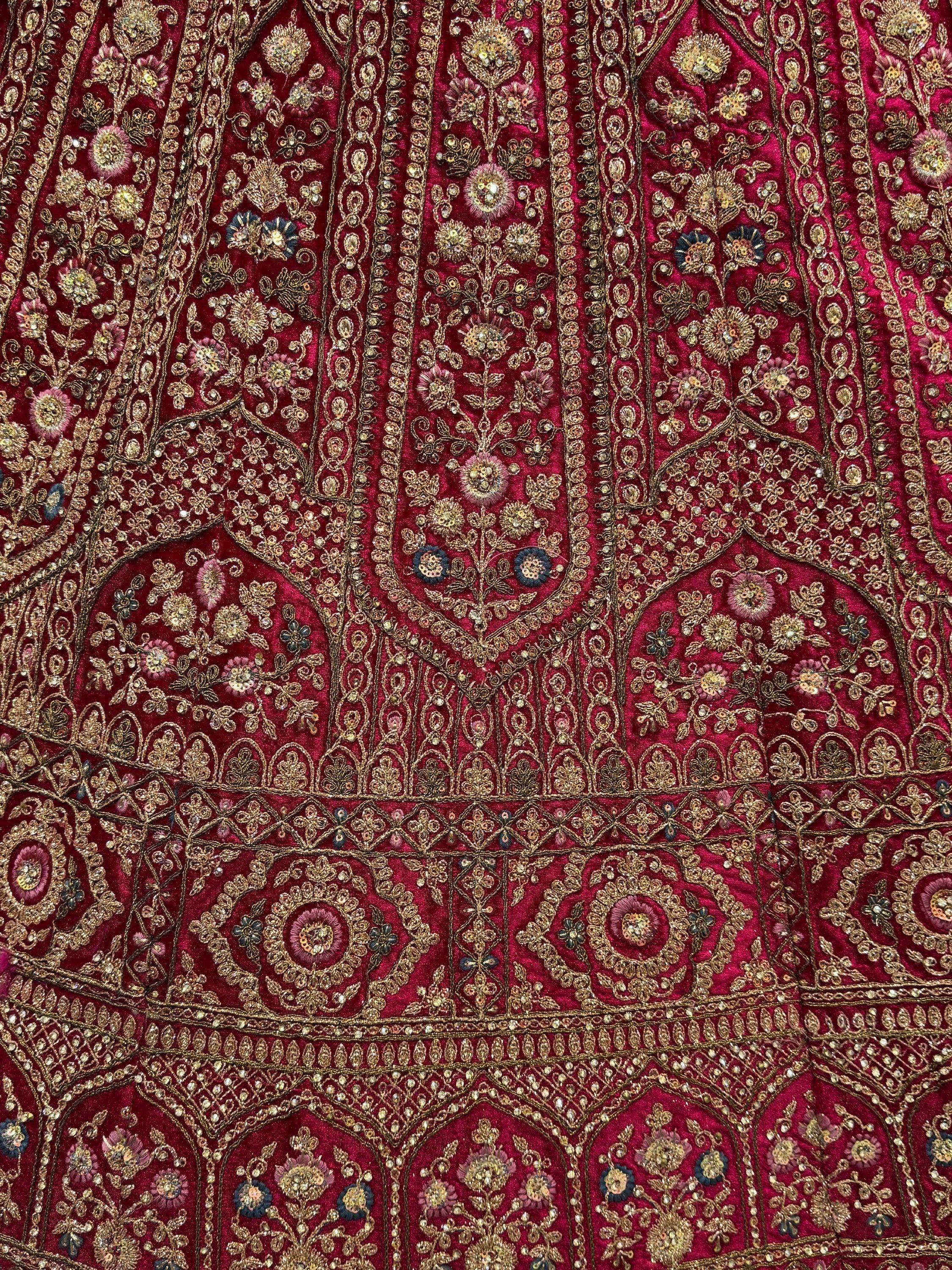 Rich maroon Indian ethnic wear with intricate gold floral embroidery and sequin detailing