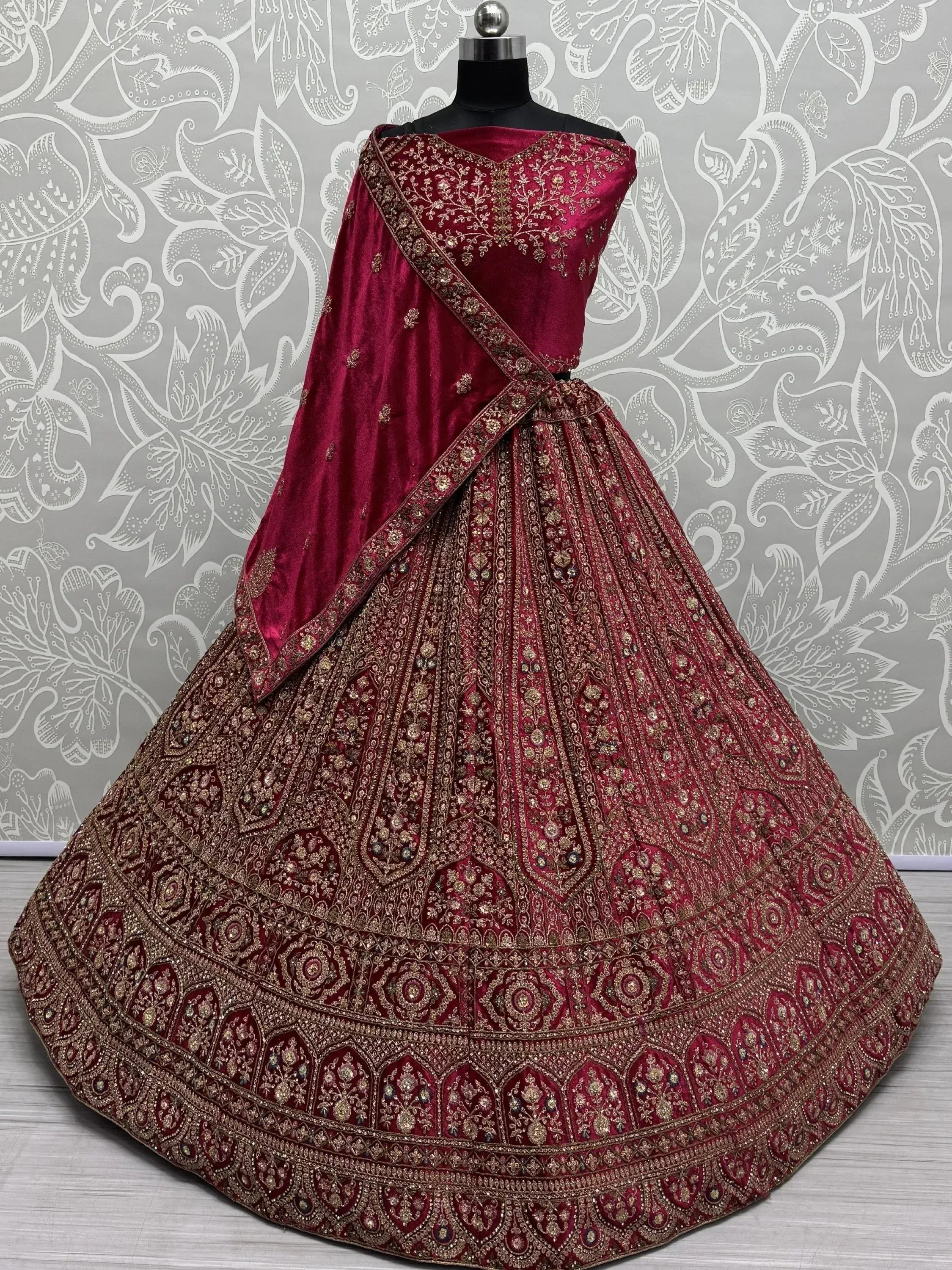 Teal and maroon embroidered lehenga choli with heavy gold work, perfect for Indian weddings and festive occasions.