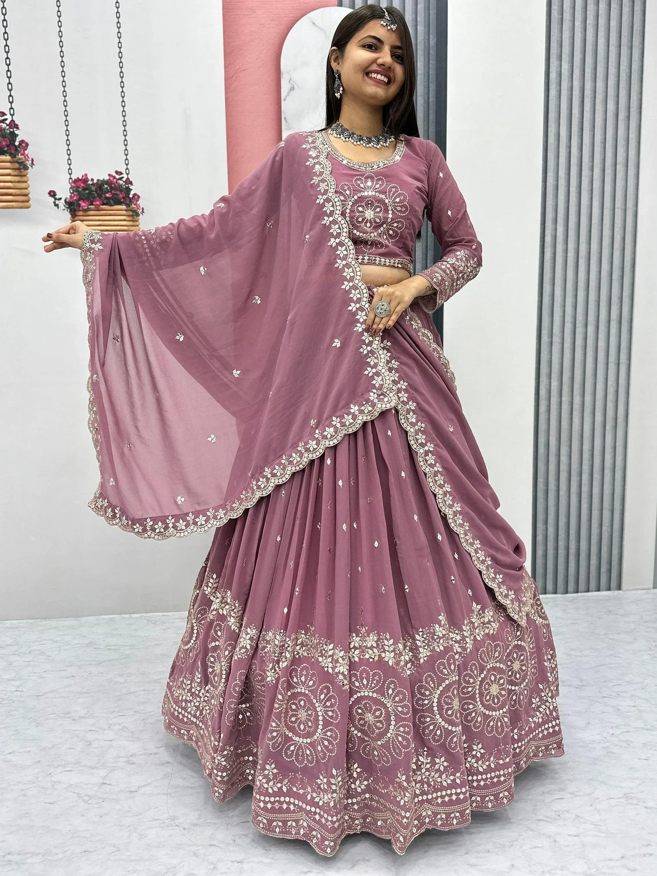 Dusty pink embroidered lehenga choli with floral mirror work, perfect for Indian ethnic wear events