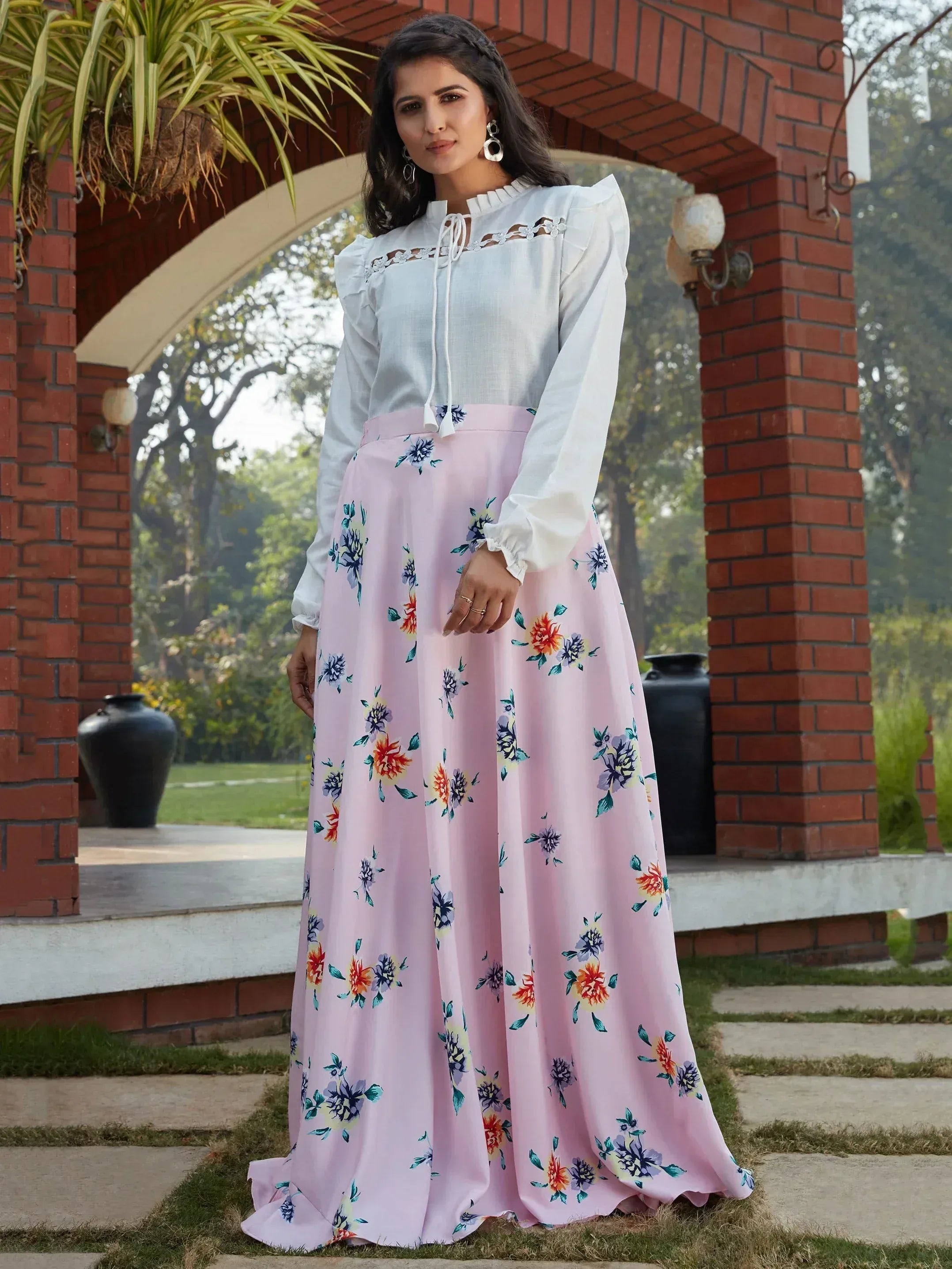 Woman in white ruffled top and pink floral skirt, Indian ethnic wear