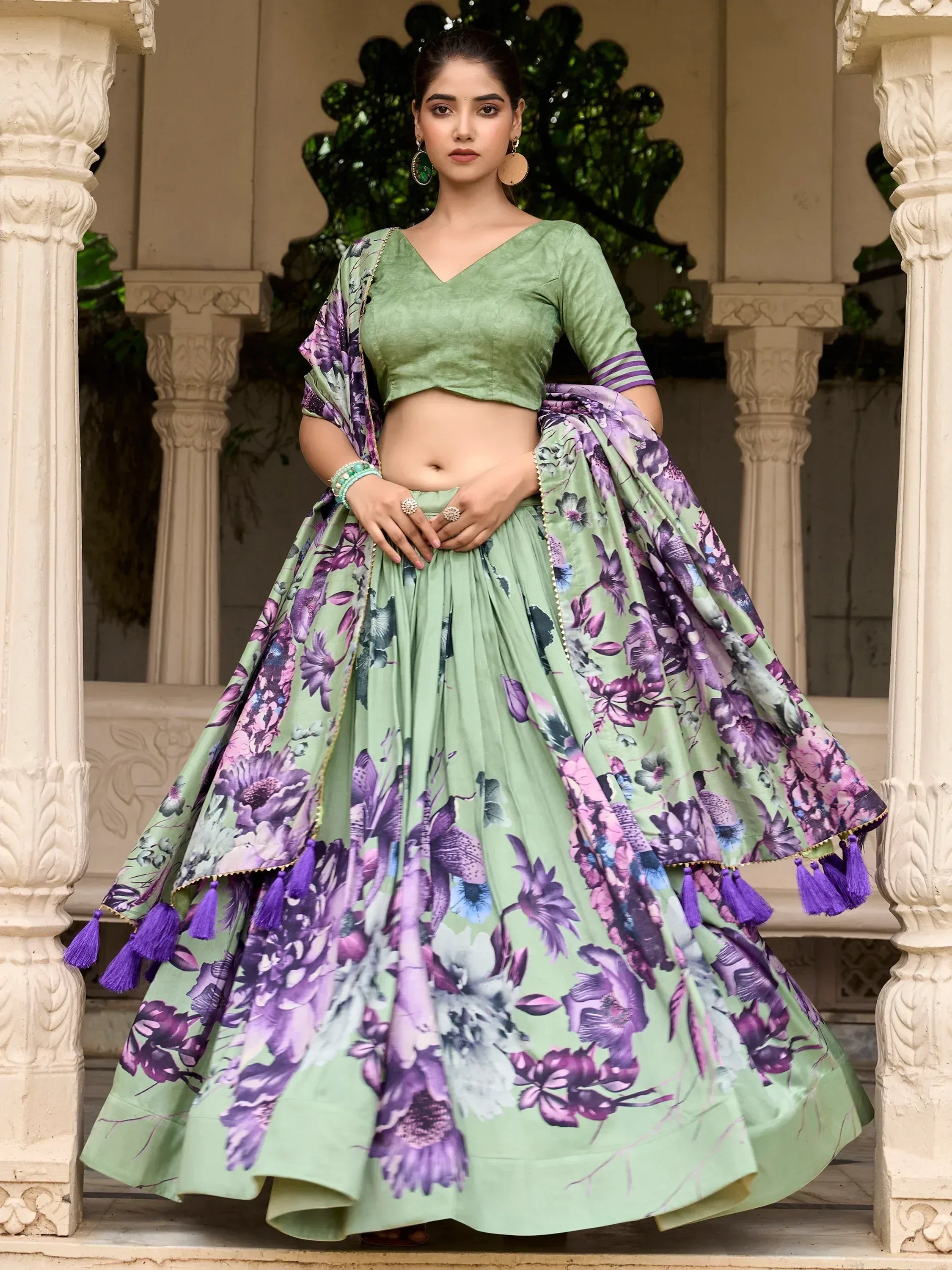 Green floral lehenga choli with purple tassels, perfect for Indian ethnic wear occasions