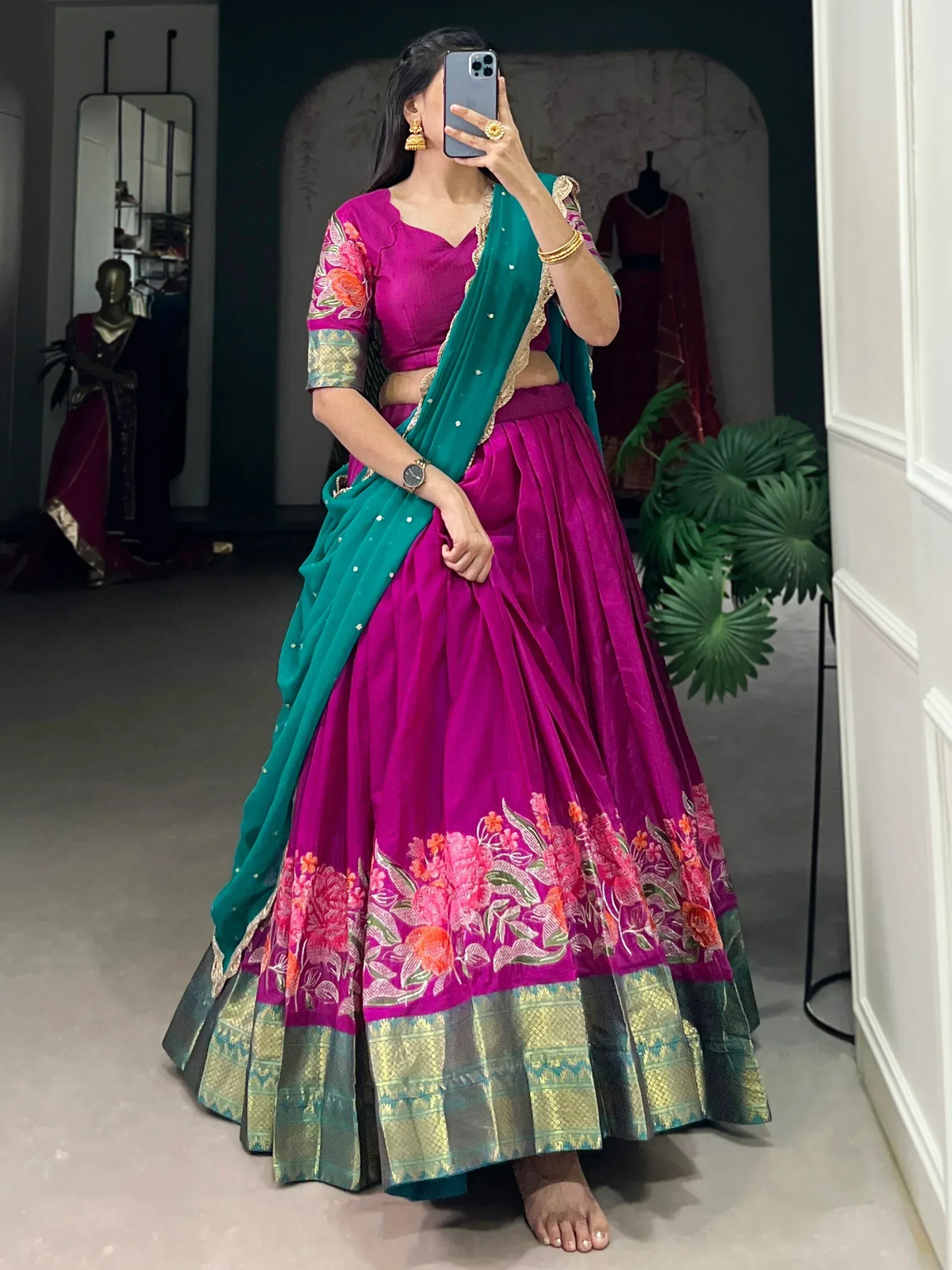 Vibrant magenta lehenga choli with floral embroidery and teal dupatta, perfect for Indian ethnic wear occasions.