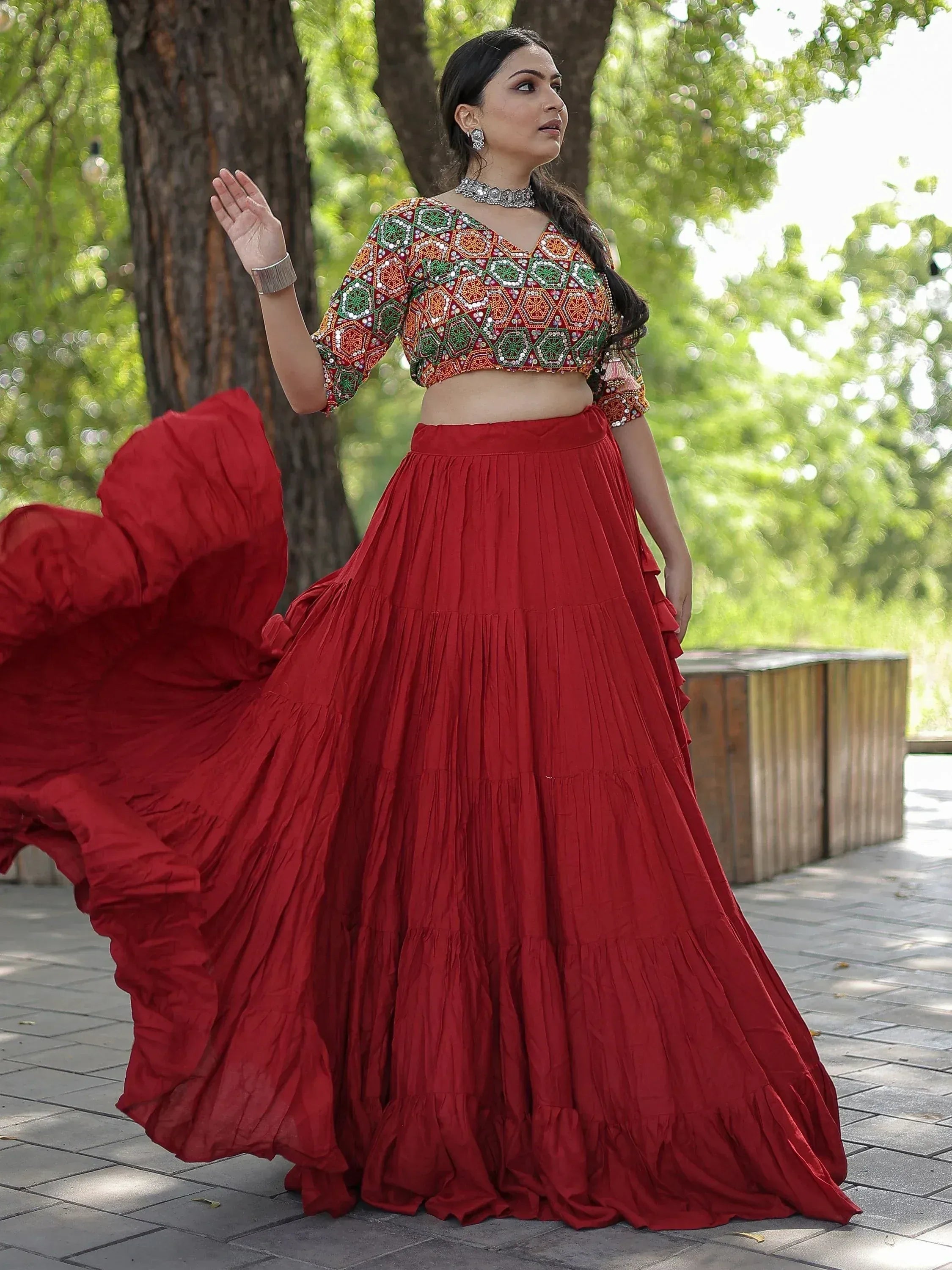 Red embroidered lehenga choli with mirror work, perfect for Indian ethnic wear and festive occasions.