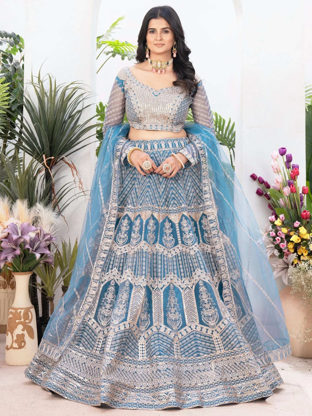 Blue embroidered lehenga choli with sheer sleeves, perfect for Indian weddings and festive occasions