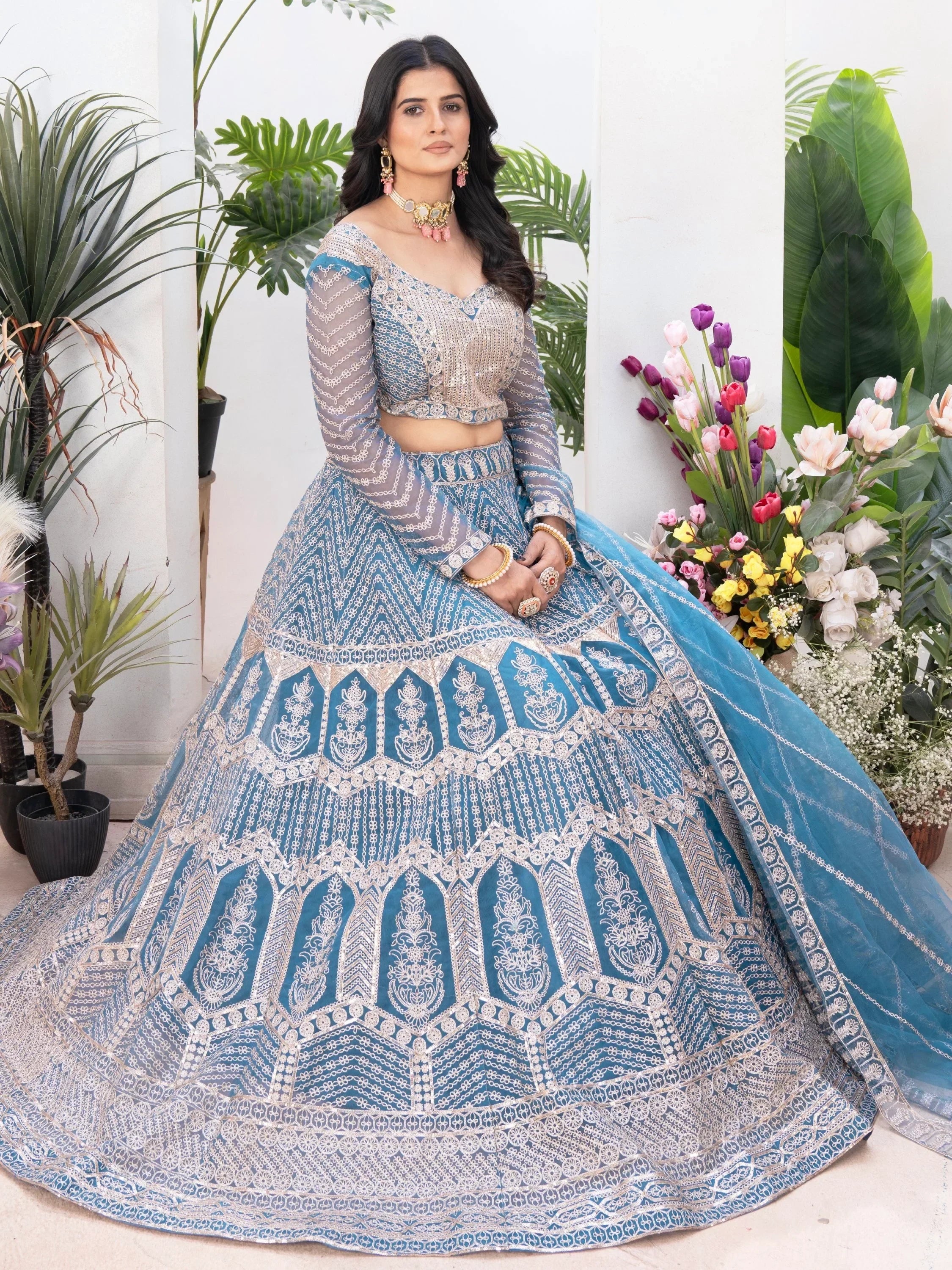 Blue embroidered lehenga choli with sheer sleeves, perfect for Indian weddings and festive occasions.