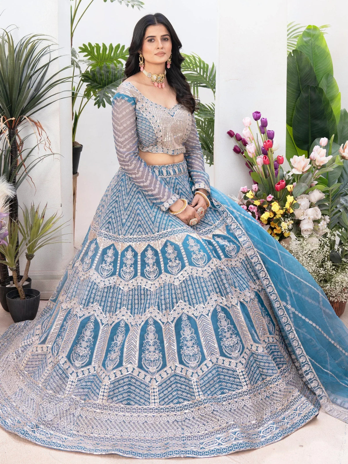 Blue embroidered lehenga choli with sheer sleeves, perfect for Indian weddings and festive occasions.