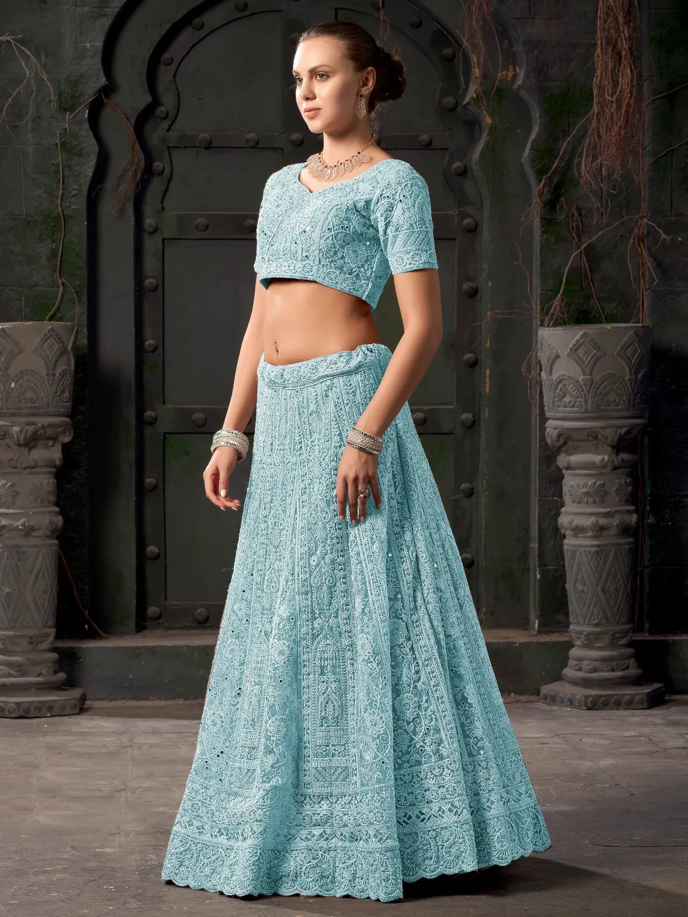 Elegant light blue designer lehenga choli with intricate embroidery, perfect for Indian ethnic wear occasions.