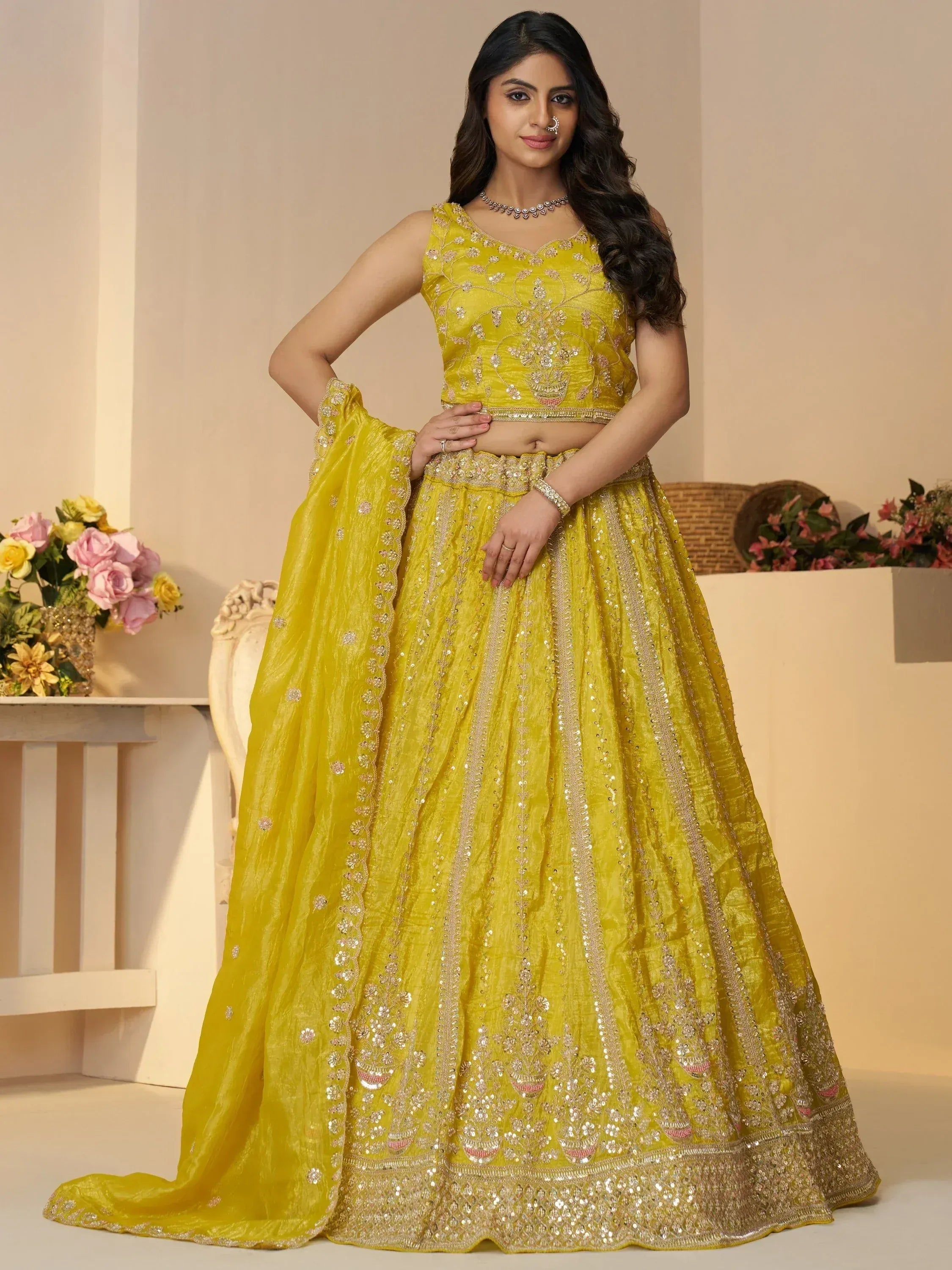Yellow designer lehenga choli with intricate embroidery and sequin work for Indian ethnic wear