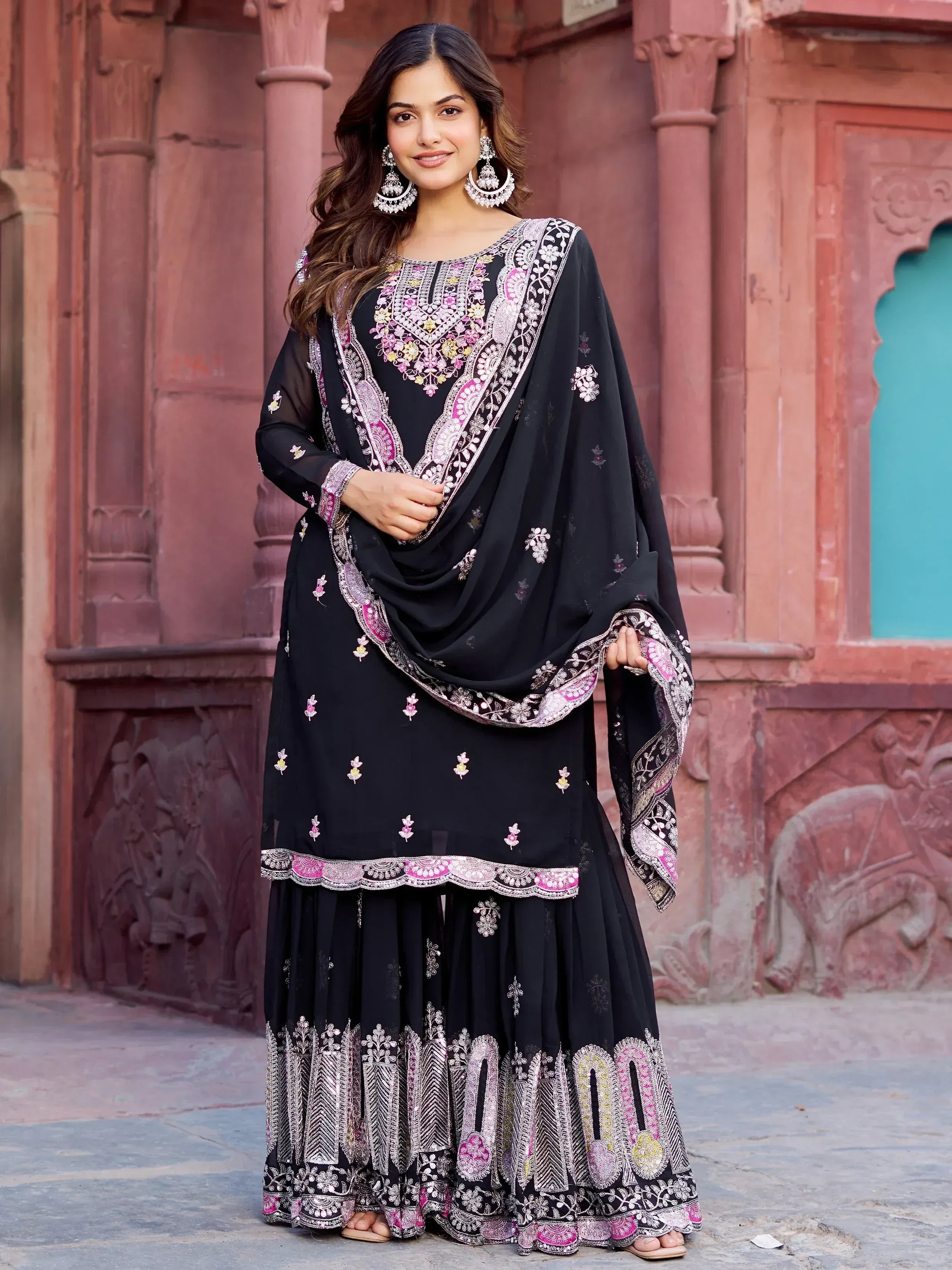 Black embroidered salwar kameez with pink and gold detailing, perfect for ethnic occasions