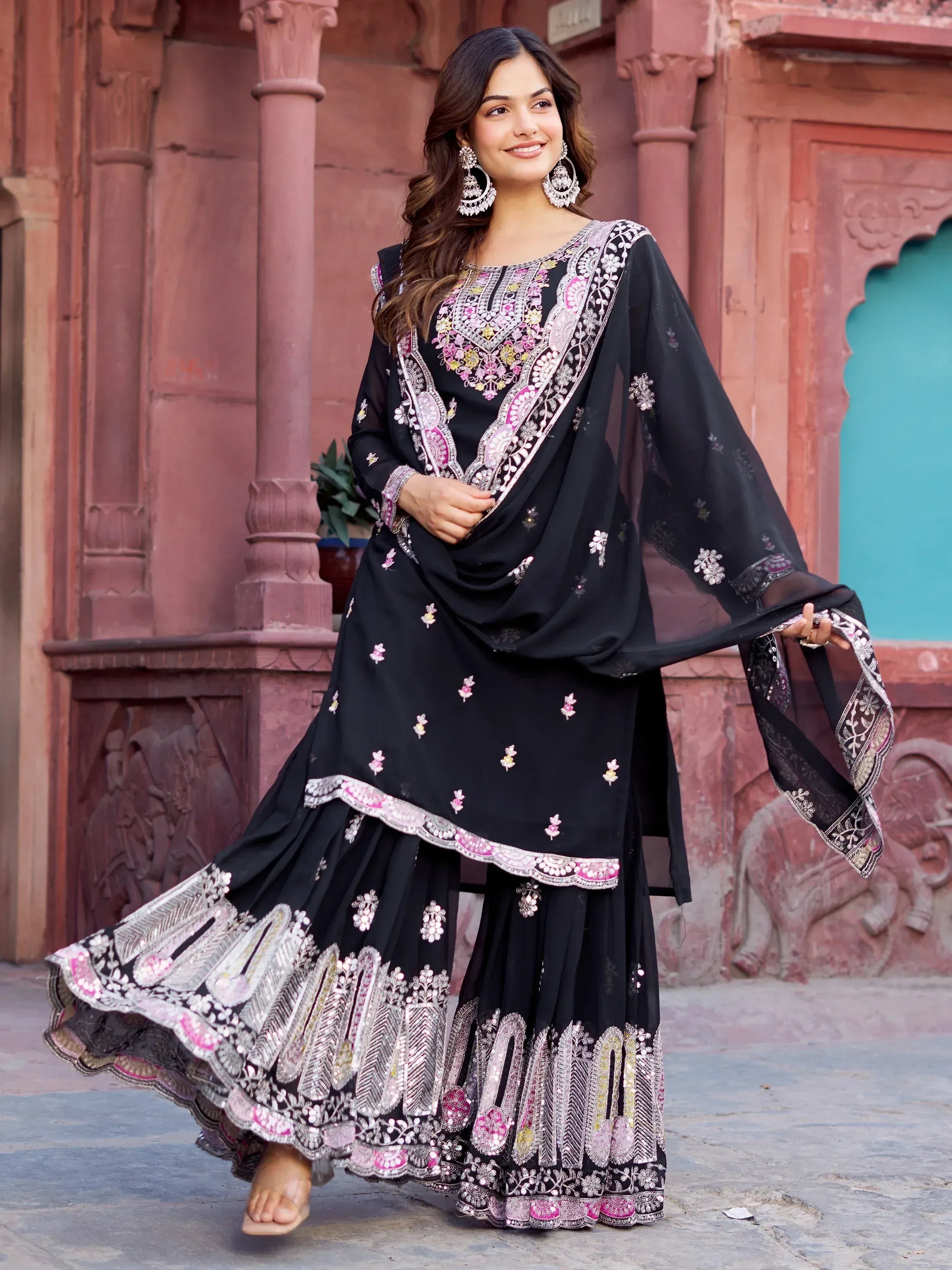 Black embroidered ethnic salwar kameez with pink and silver detailing, perfect for festive occasions.