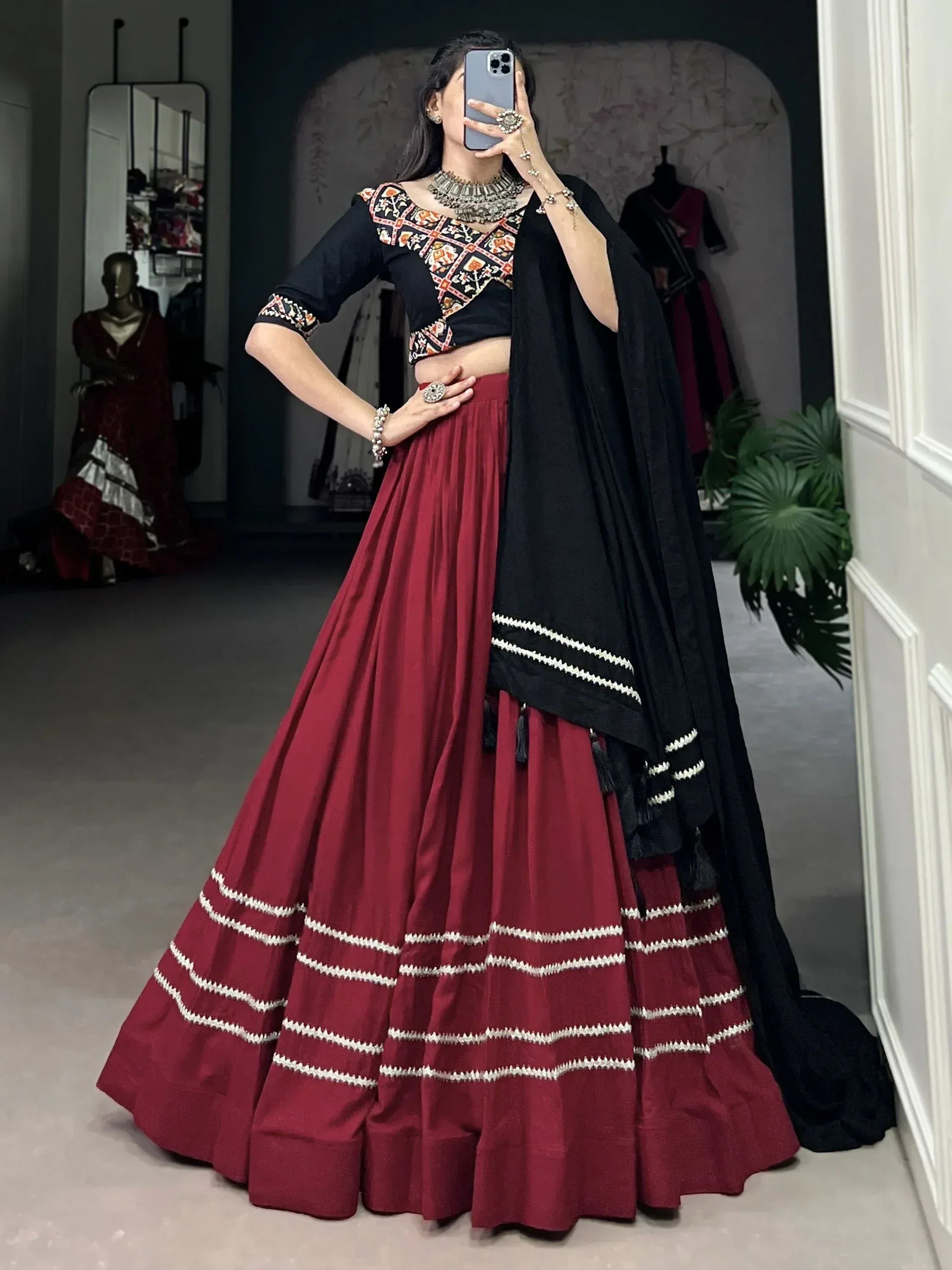 Woman in maroon lehenga choli with black embroidered blouse and dupatta, traditional Indian ethnic wear