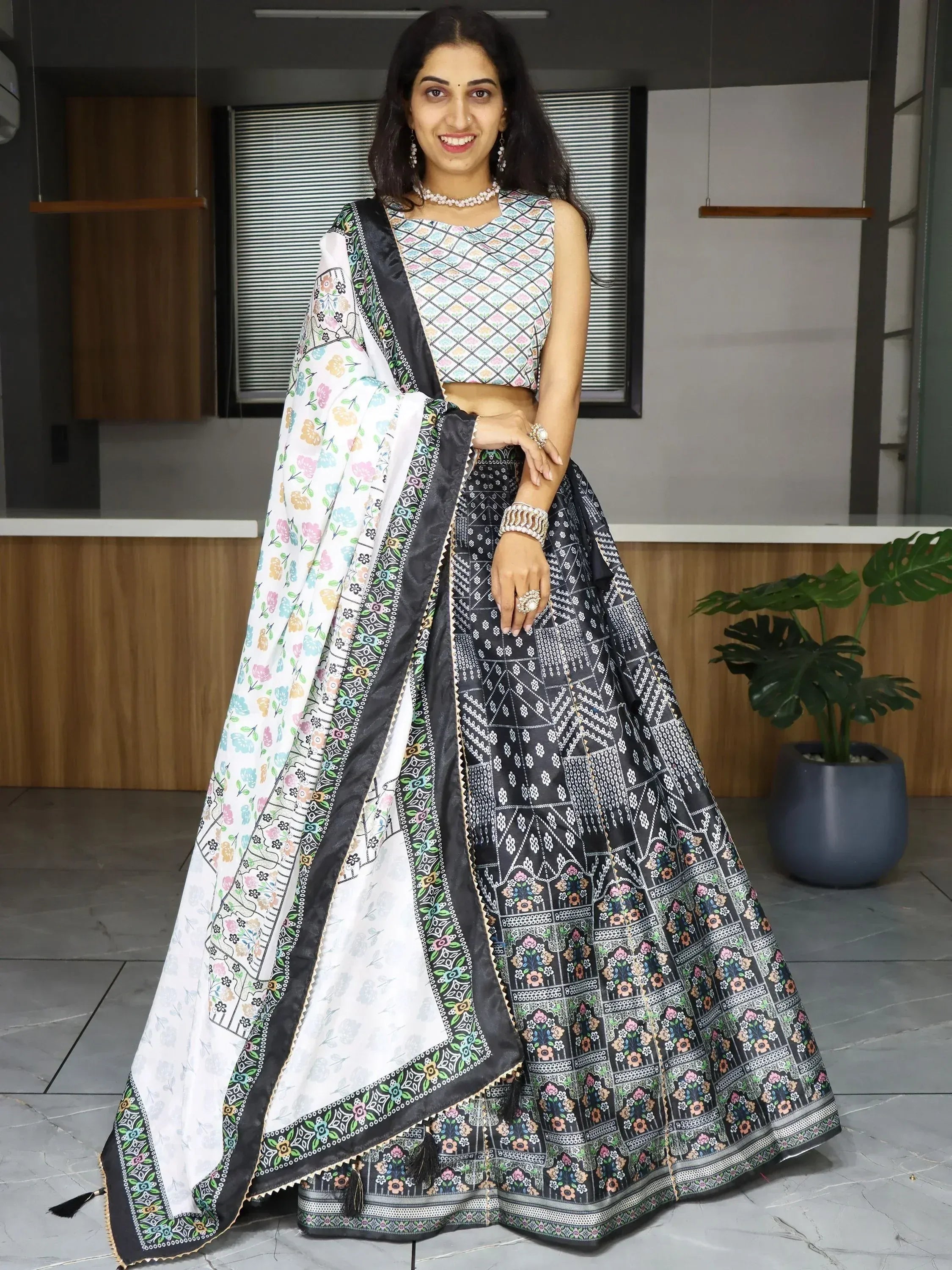 Woman in black and white floral lehenga choli with colorful dupatta, Indian ethnic wear