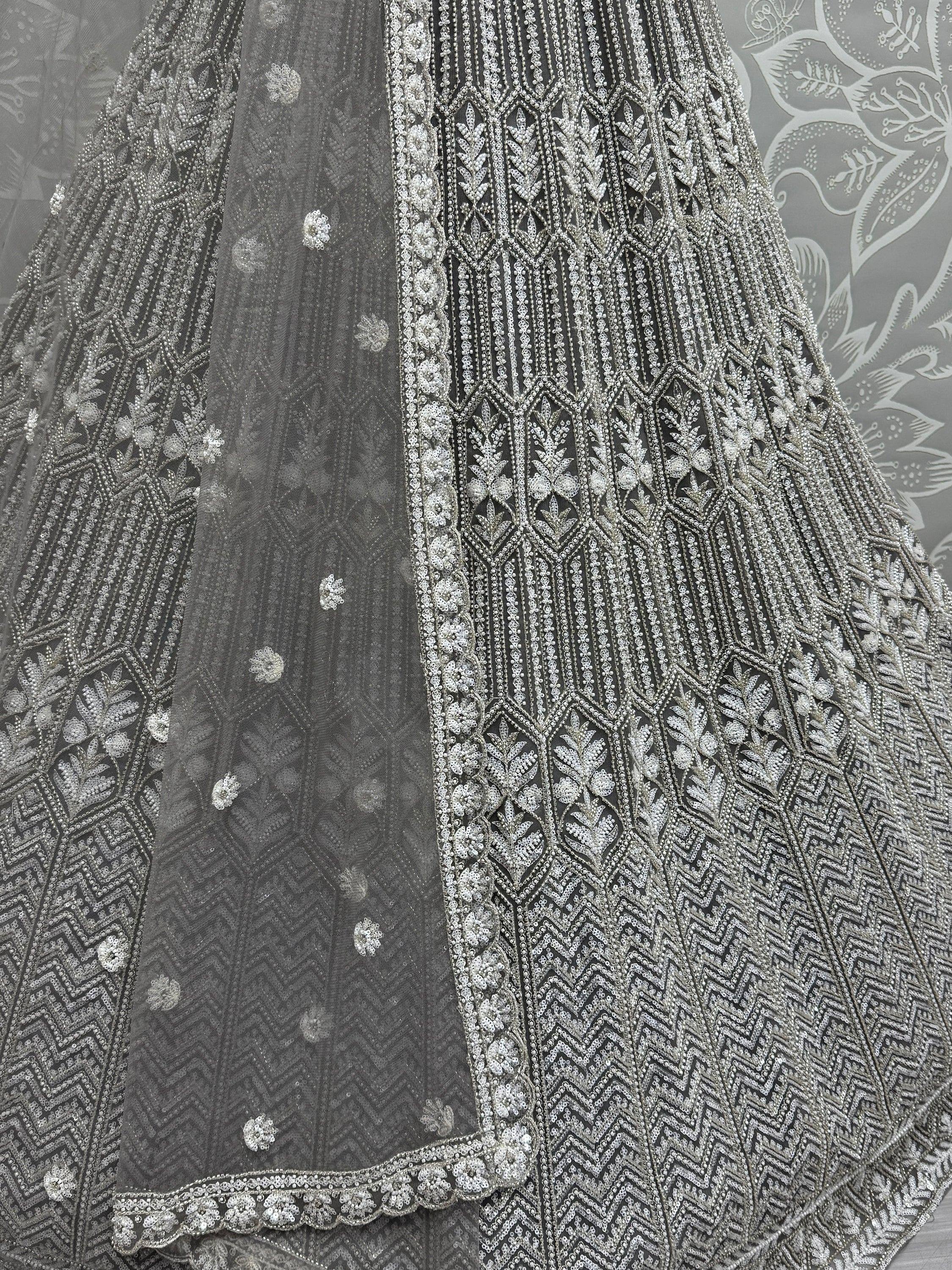 Grey designer lehenga with intricate silver embroidery and sequin work, perfect for Indian ethnic wear.