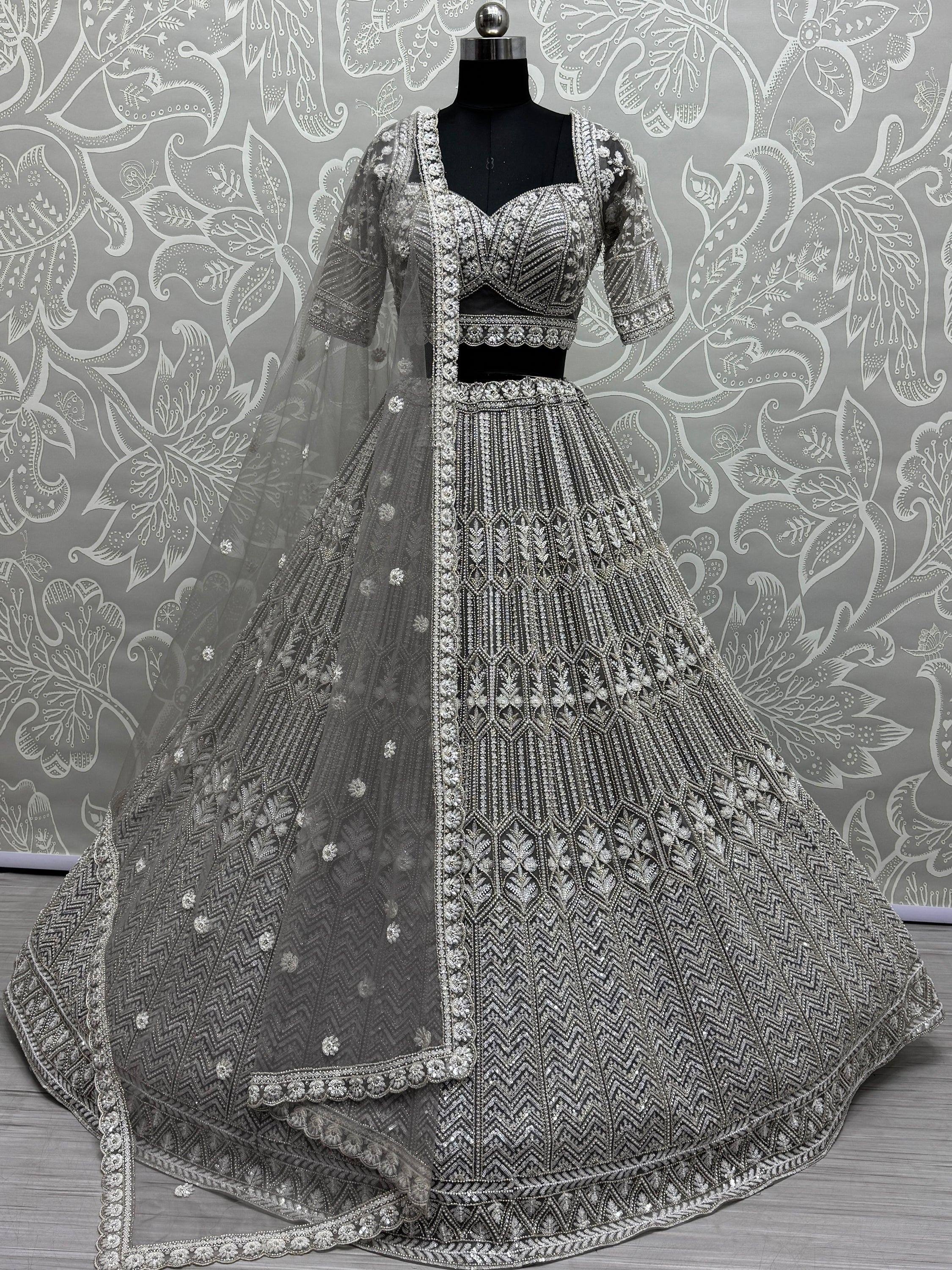 Grey designer lehenga choli with heavy silver embroidery and net dupatta, perfect for weddings and parties.