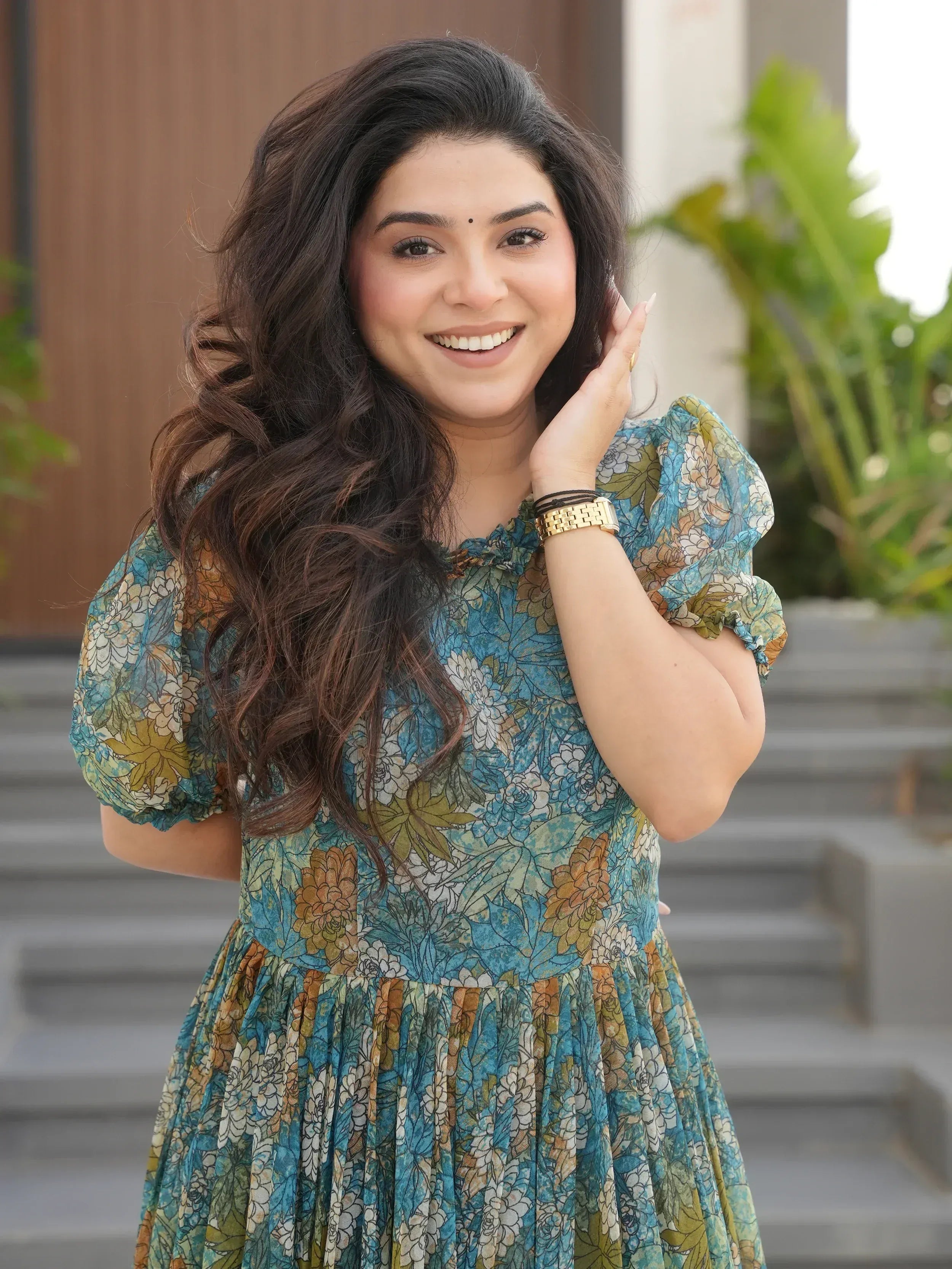 Woman in floral ethnic gown with puff sleeves, perfect for Indian occasions and festive wear.