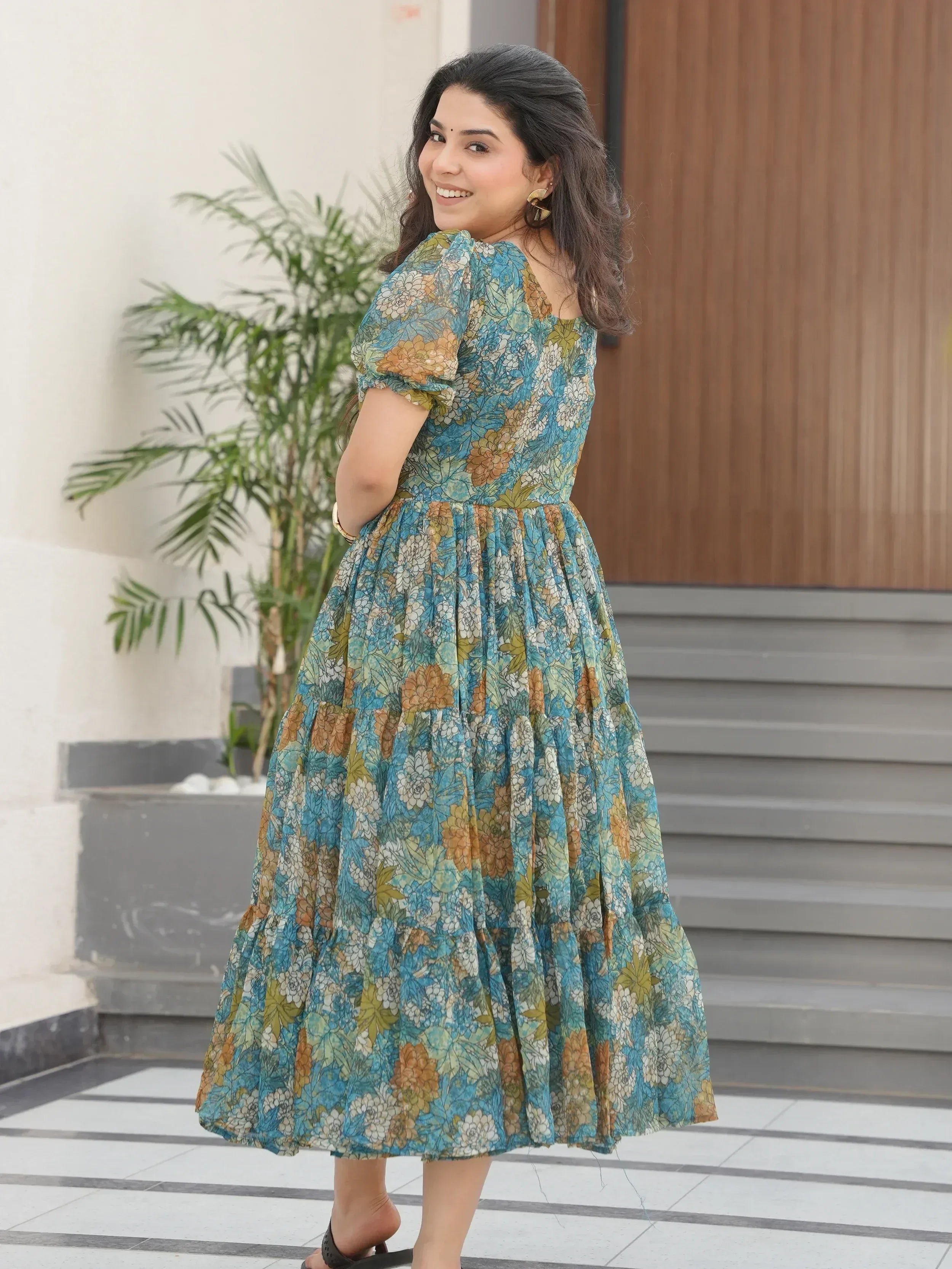 Woman in blue floral ethnic gown with puff sleeves, perfect for Indian occasions and daily wear.