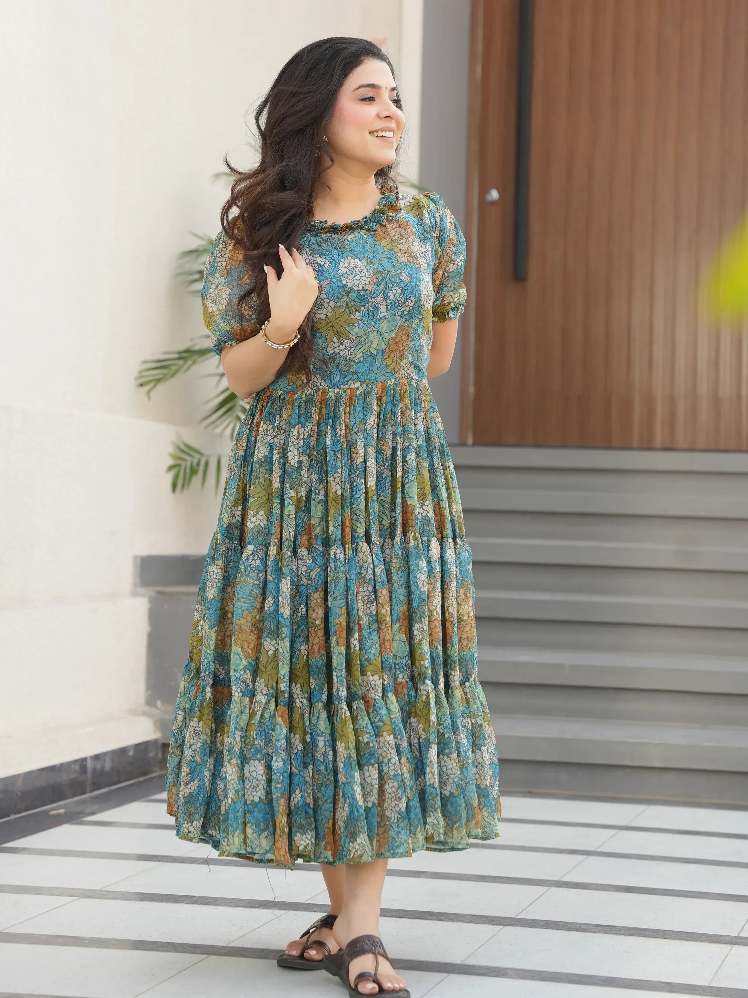 Woman in blue floral ethnic gown with puff sleeves, perfect for casual occasions