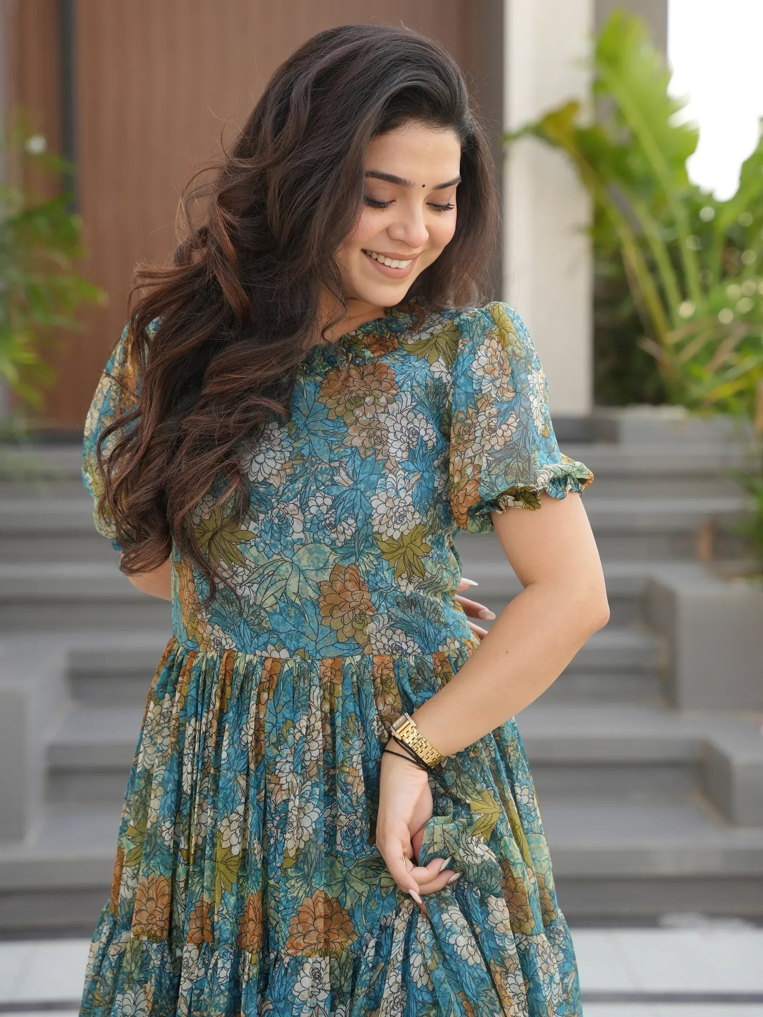 Woman in floral print ethnic gown with puff sleeves, perfect for Indian occasions and festive wear.