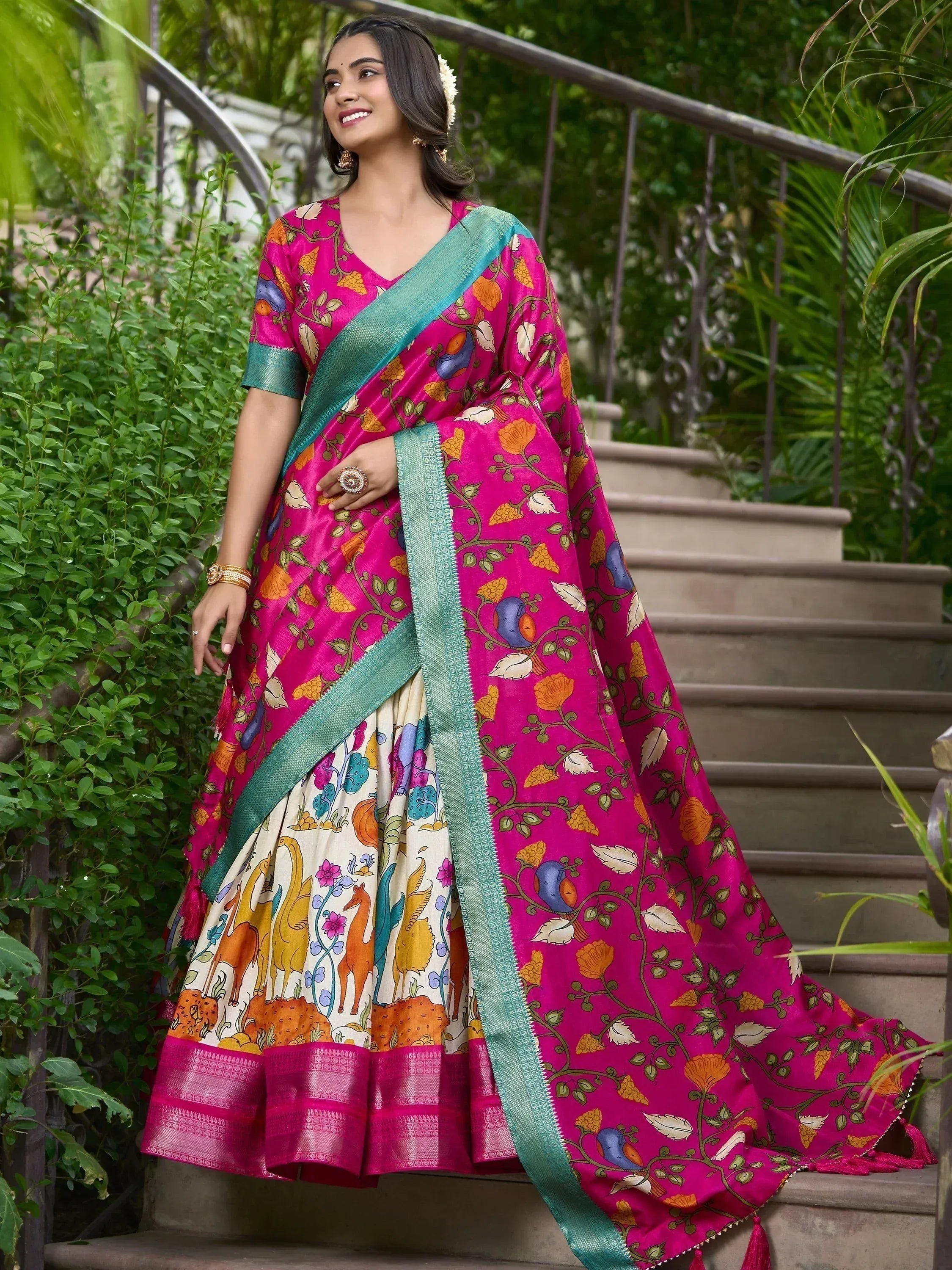 Vibrant pink floral lehenga choli with teal border, perfect for Indian ethnic occasions
